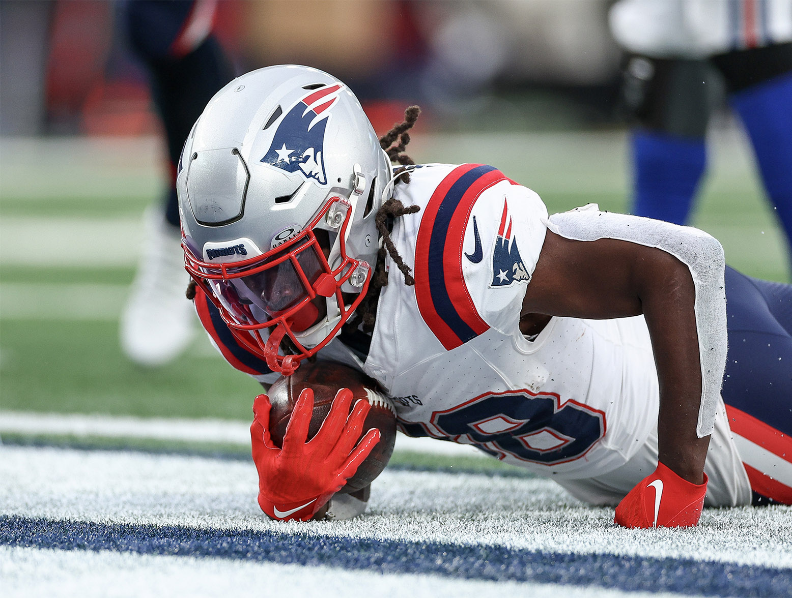 EAST RUTHERFORD, NEW JERSEY - NOVEMBER 26: Rhamondre Stevenson #38 of the New England Patriots scores a rushing touchdown during the third quarter against the New York Giants at MetLife Stadium on November 26, 2023 in East Rutherford, New Jersey. (Photo by Elsa/Getty Images)