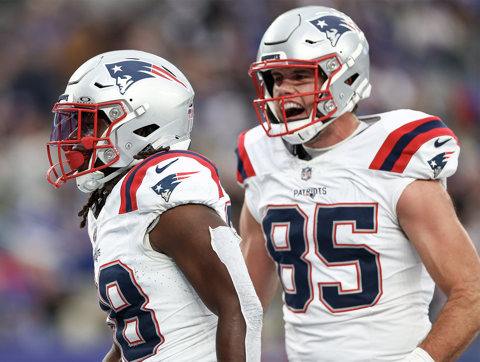 EAST RUTHERFORD, NEW JERSEY - NOVEMBER 26: Rhamondre Stevenson #38 of the New England Patriots and Hunter Henry #85 of the New England Patriots celebrates after Stevenson's rushing touchdown during the third quarter against the New York Giants at MetLife Stadium on November 26, 2023 in East Rutherford, New Jersey. (Photo by Elsa/Getty Images)