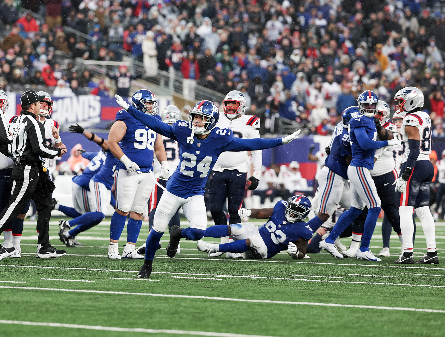 EAST RUTHERFORD, NEW JERSEY - NOVEMBER 26: Dane Belton #24 of the New York Giants celebrates after a missed field goal during the fourth quarter against the New England Patriots at MetLife Stadium on November 26, 2023 in East Rutherford, New Jersey. (Photo by Al Bello/Getty Images)