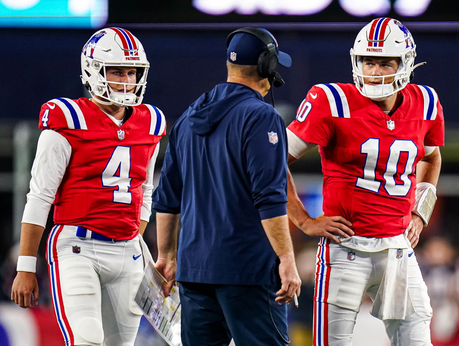 Sep 17, 2023; Foxborough, Massachusetts, USA; New England Patriots quarterback Mac Jones (10) and quarterback Bailey Zappe (4) talk with offensive coordinator/quarterbacks coach Bill O'Brien in the second quarter at Gillette Stadium. Credit: David Butler II-USA TODAY Sports