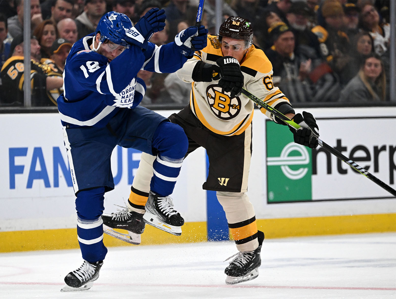 Nov 2, 2023; Boston, Massachusetts, USA; Toronto Maple Leafs center Noah Gregor (18) checks Boston Bruins left wing Brad Marchand (63) during the first period at the TD Garden. Mandatory Credit: Brian Fluharty-USA TODAY Sports