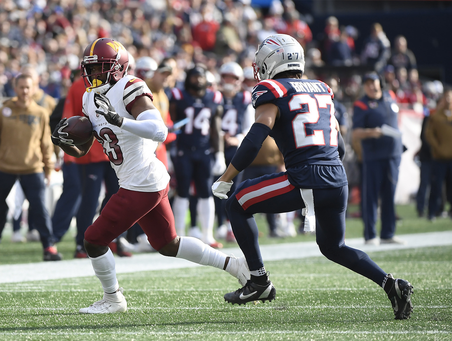 Nov 5, 2023; Foxborough, Massachusetts, USA; Washington Commanders wide receiver Jamison Crowder (83) runs with the ball wile New England Patriots cornerback Myles Bryant (27) defends during the first half at Gillette Stadium. Mandatory Credit: Bob DeChiara-USA TODAY Sports