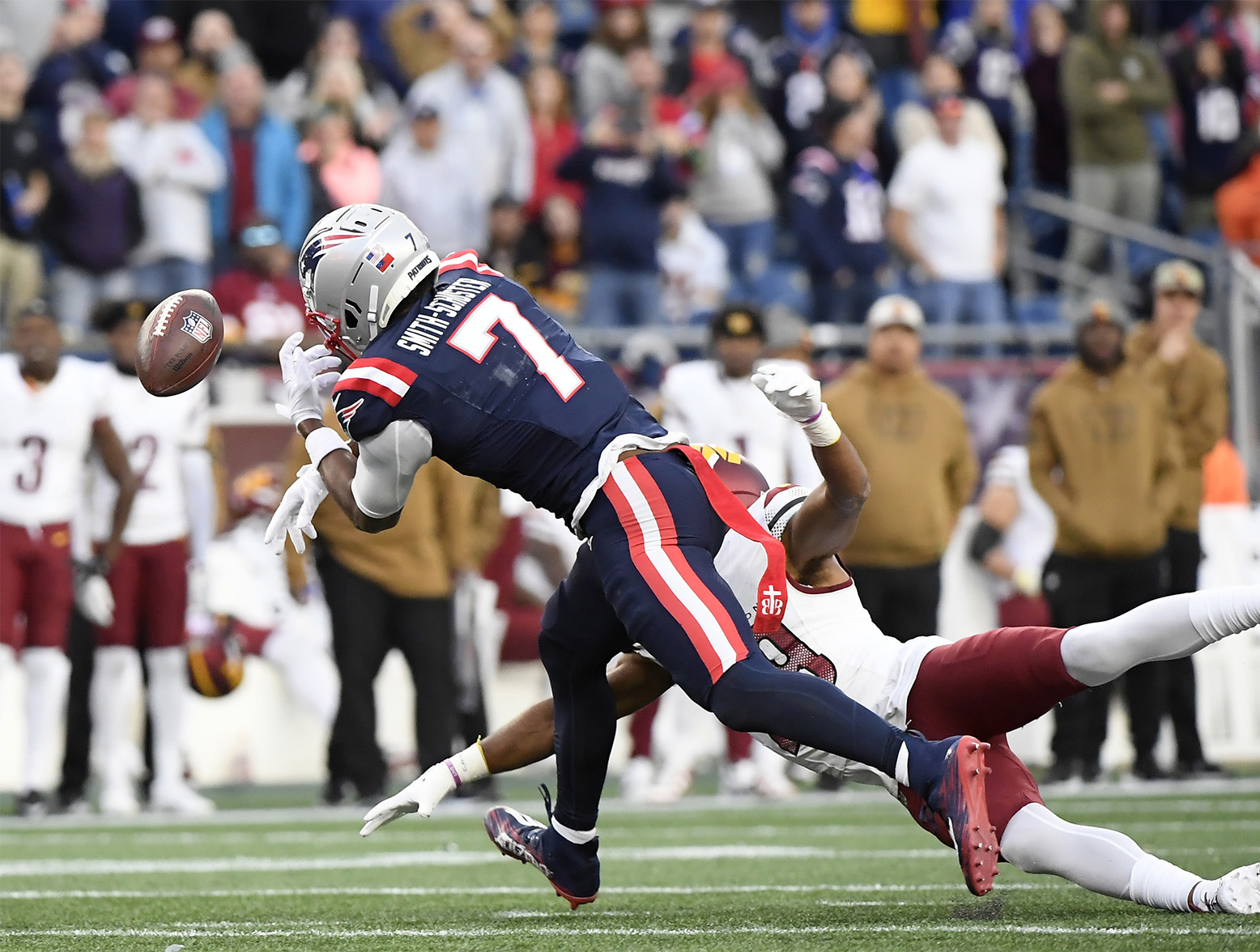 Nov 5, 2023; Foxborough, Massachusetts, USA; New England Patriots wide receiver JuJu Smith-Schuster (7) has the ball got through his hands during the second half against the Washington Commanders at Gillette Stadium. Mandatory Credit: Bob DeChiara-USA TODAY Sports