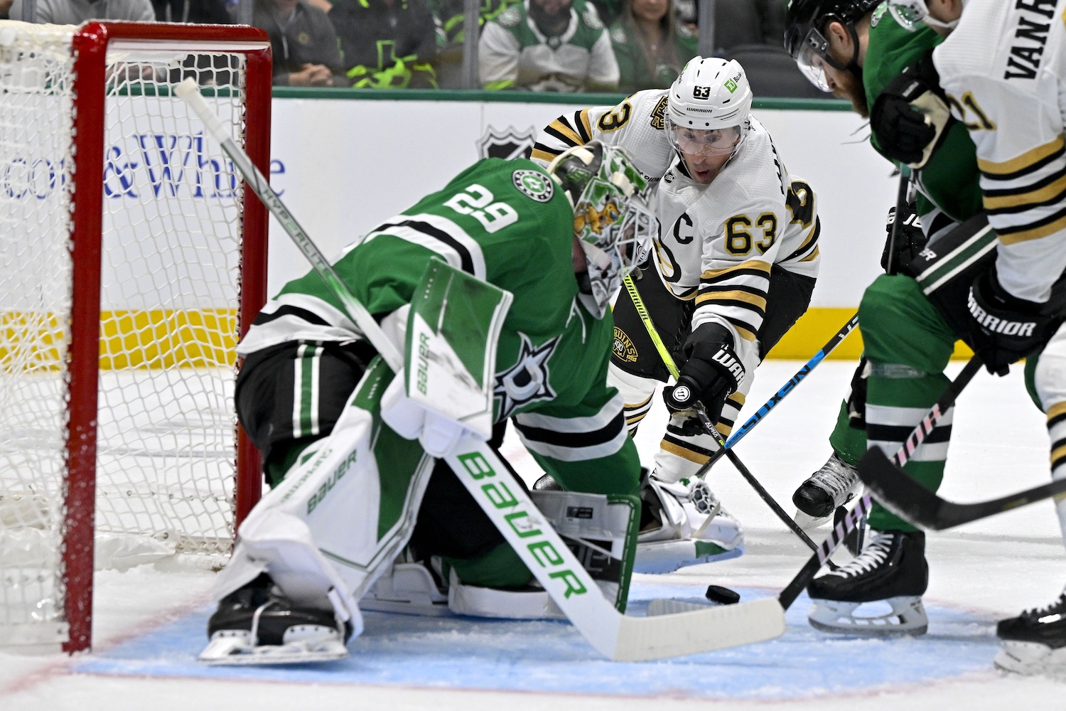 Nov 6, 2023; Dallas, Texas, USA; Dallas Stars goaltender Jake Oettinger (29) covers up the puck n front of Boston Bruins left wing Brad Marchand (63) during the first period at the American Airlines Center. Mandatory Credit: Jerome Miron-USA TODAY Sports