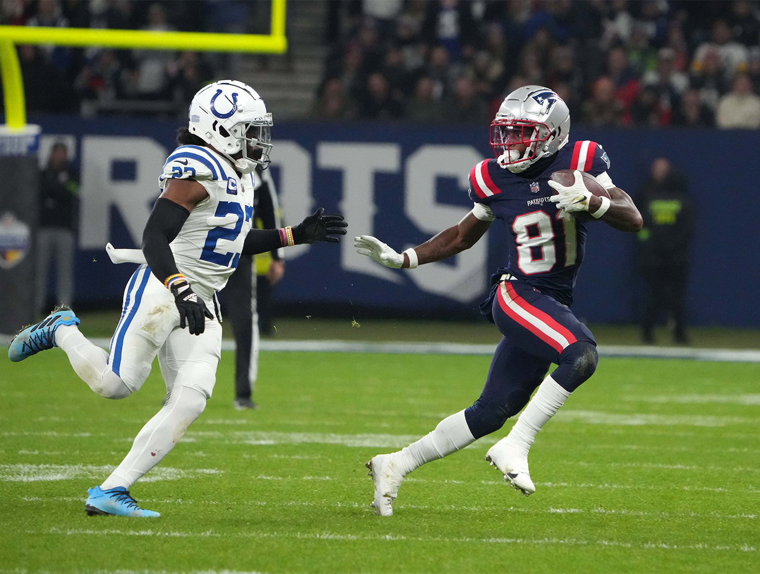 Nov 12, 2023; Frankfurt, Germany; New England Patriots wide receiver Demario Douglas (81) carries the ball against Indianapolis Colts running back Trey Sermon (27) in the second half during an NFL International Series game at Deutsche Bank Park. Mandatory Credit: Kirby Lee-USA TODAY Sports