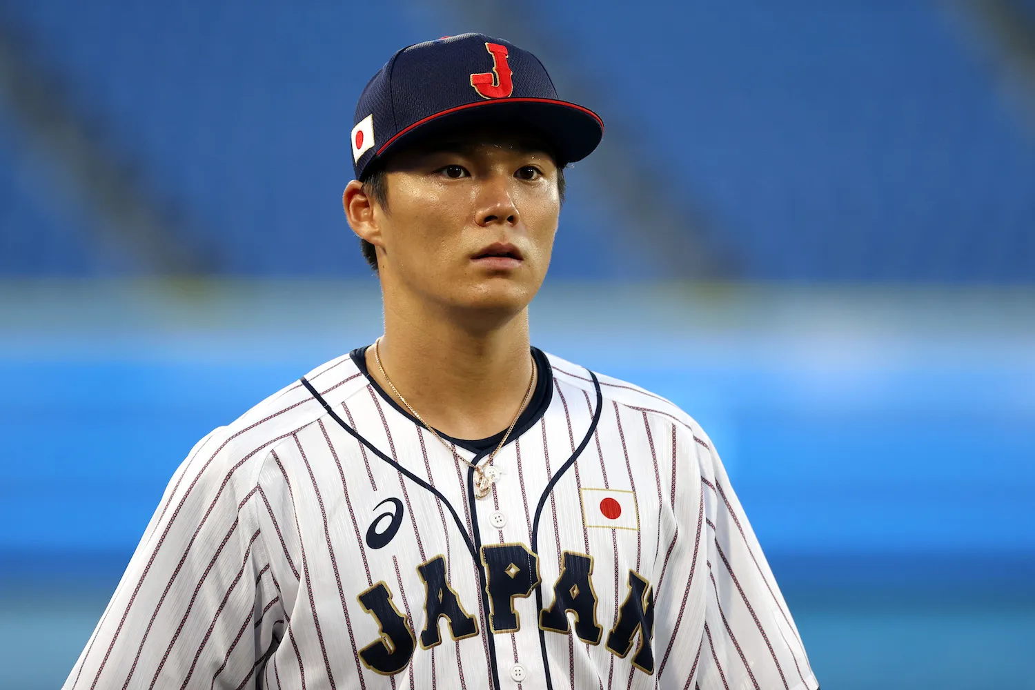 YOKOHAMA, JAPAN - AUGUST 04: Yoshinobu Yamamoto #17 of Team Japan looks on before the game against Team Republic of Korea during the semifinals of men's baseball on day twelve of the Tokyo 2020 Olympic Games at Yokohama Baseball Stadium on August 04, 2021 in Yokohama, Japan. (Photo by Koji Watanabe/Getty Images)