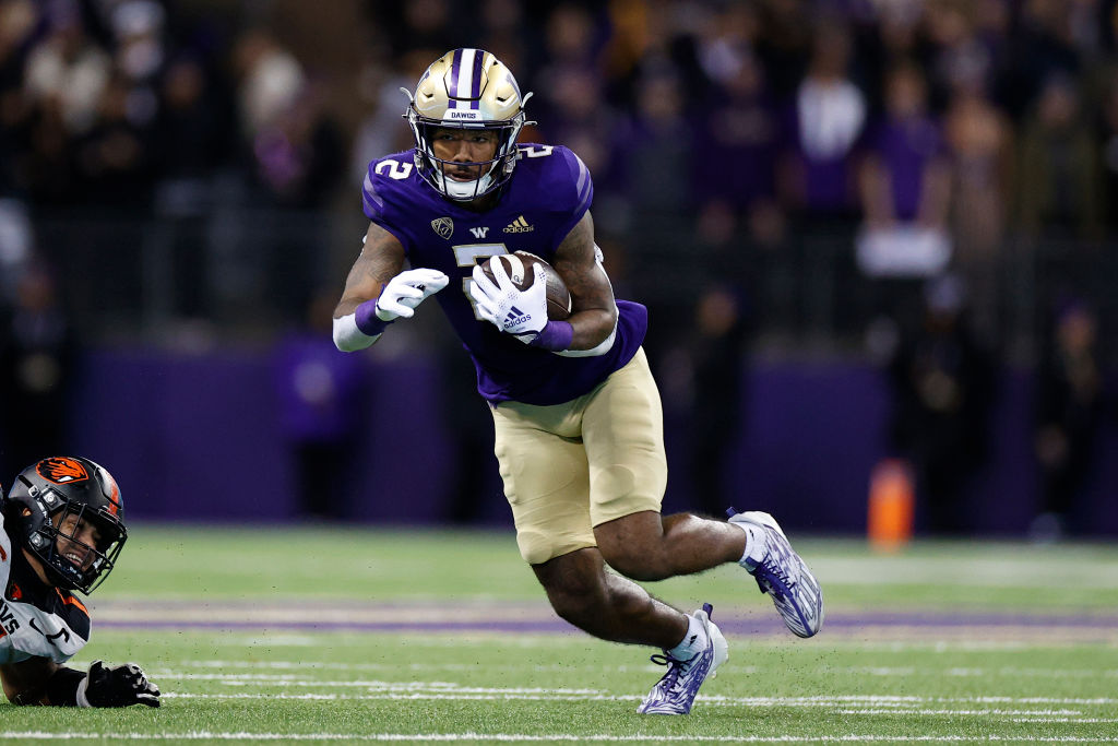 SEATTLE, WASHINGTON - NOVEMBER 04: Ja'Lynn Polk #2 of the Washington Huskies carries the ball against the Oregon State Beavers at Husky Stadium on November 04, 2022 in Seattle, Washington. (Photo by Steph Chambers/Getty Images)