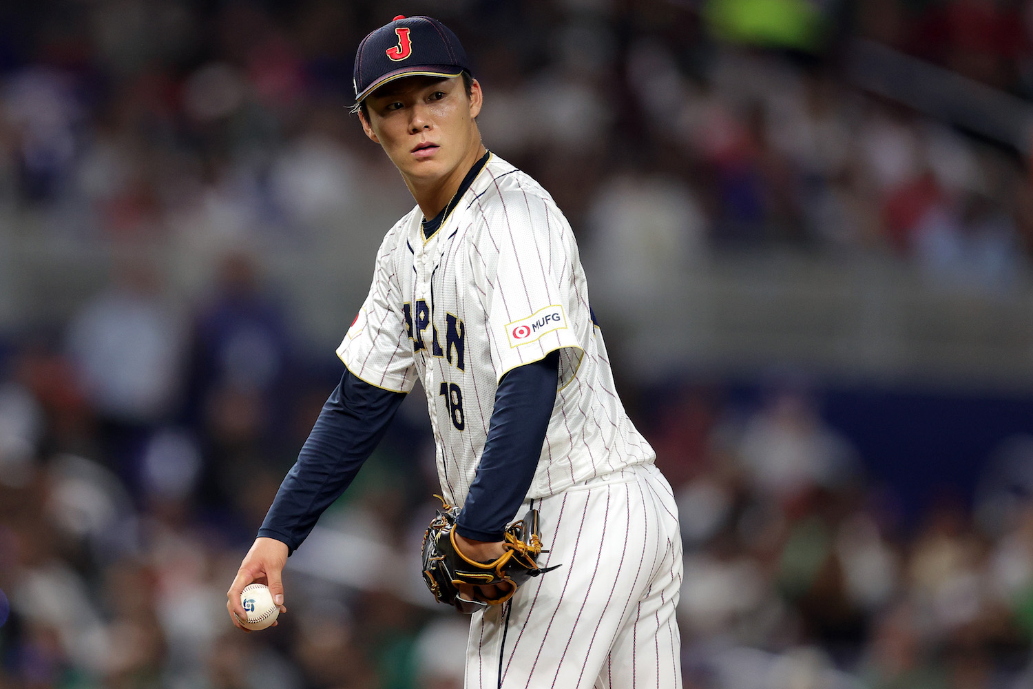 MIAMI, FLORIDA - MARCH 20: Yoshinobu Yamamoto #18 of Team Japan looks on during the fifth inning against Team Mexico during the World Baseball Classic Semifinals at loanDepot park on March 20, 2023 in Miami, Florida. (Photo by Megan Briggs/Getty Images)