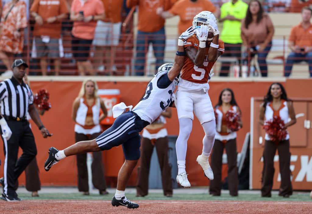 AUSTIN, TEXAS - OCTOBER 28: Adonai Mitchell #5 of the Texas Longhorns catches a pass for a touchdown in the second quarter while defended by Raider Damuni #33 of the Brigham Young Cougars at Darrell K Royal-Texas Memorial Stadium on October 28, 2023 in Austin, Texas. (Photo by Tim Warner/Getty Images)