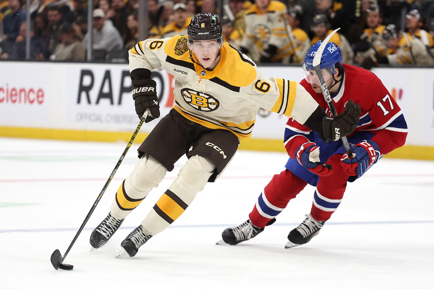 BOSTON, MASSACHUSETTS - NOVEMBER 18: Mason Lohrei #6 of the Boston Bruins skates past Josh Anderson #17 of the Montreal Canadiens during the third period at TD Garden on November 18, 2023 in Boston, Massachusetts. The Bruins defeat the Canadiens 5-2. (Photo by Maddie Meyer/Getty Images)