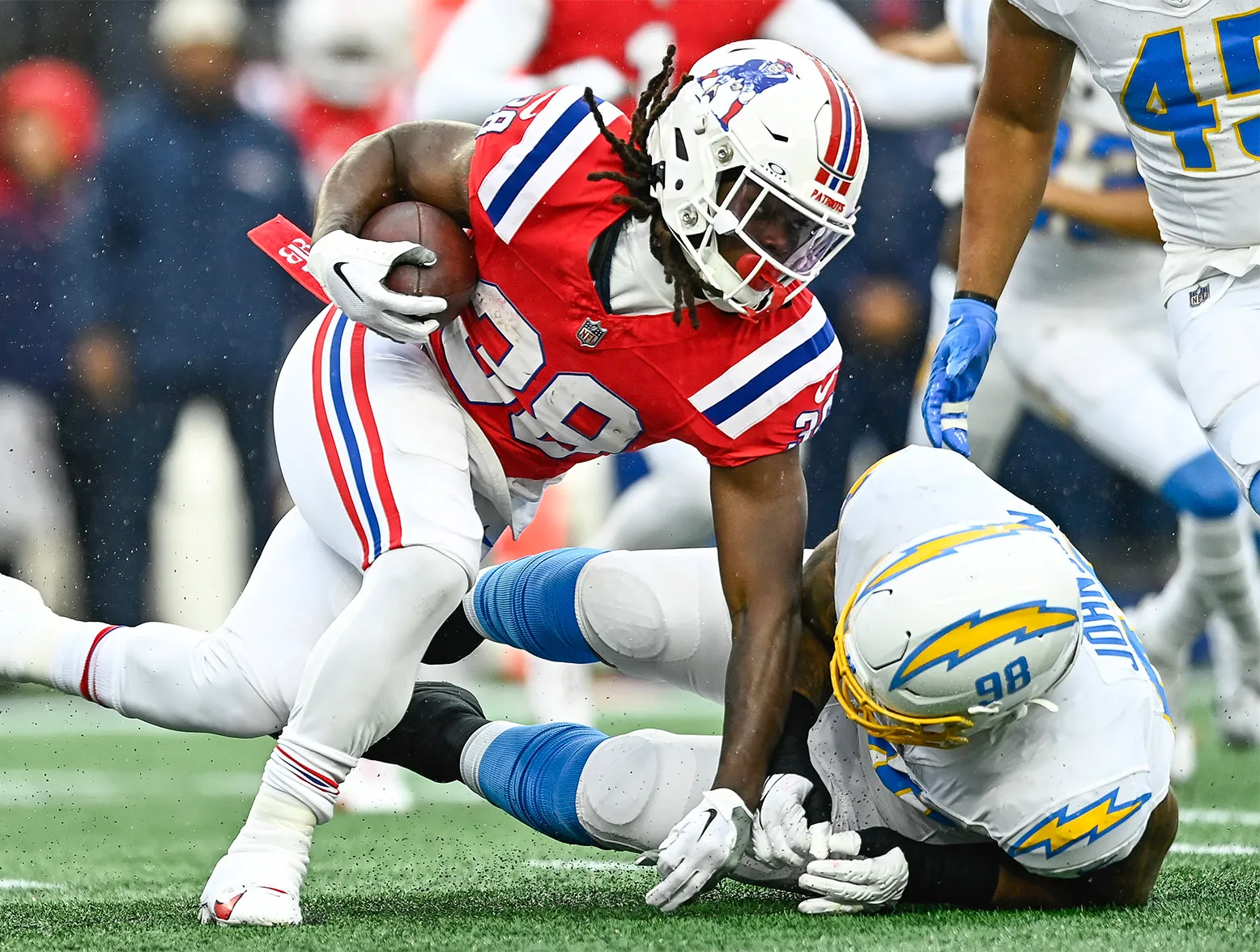 FOXBOROUGH, MASSACHUSETTS - DECEMBER 03: Rhamondre Stevenson #38 of the New England Patriots runs with the ball in the first quarter against the Los Angeles Chargers at Gillette Stadium on December 03, 2023 in Foxborough, Massachusetts. (Photo by Billie Weiss/Getty Images)