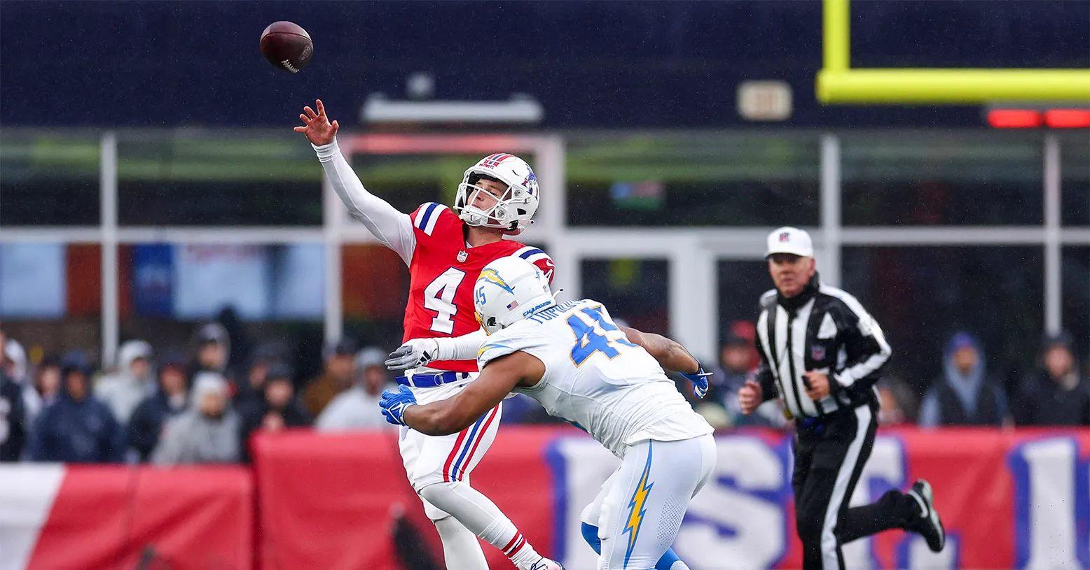 FOXBOROUGH, MASSACHUSETTS - DECEMBER 03: Bailey Zappe #4 of the New England Patriots throws a pass while being chased by Tuli Tuipulotu #45 of the Los Angeles Chargers in the second quarter at Gillette Stadium on December 03, 2023 in Foxborough, Massachusetts. (Photo by Maddie Meyer/Getty Images)
