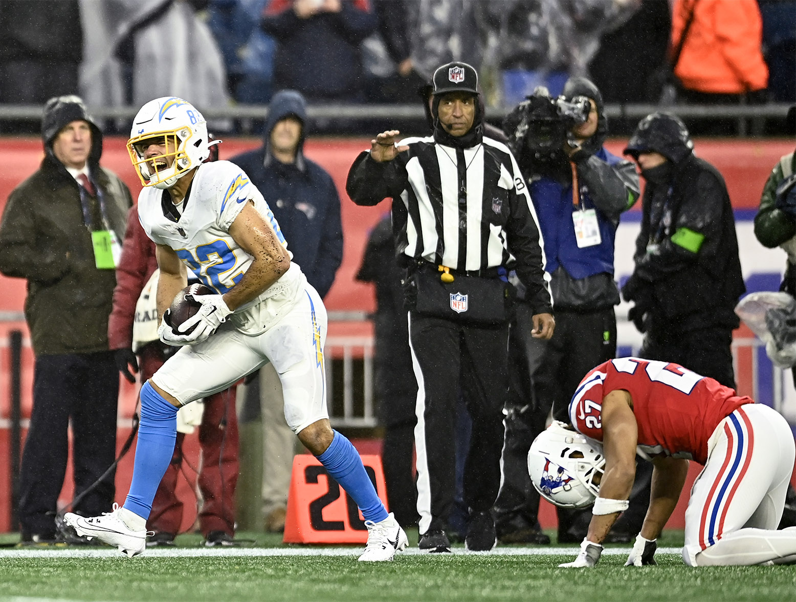 FOXBOROUGH, MASSACHUSETTS - DECEMBER 03: Alex Erickson #82 of the Los Angeles Chargers reacts after making a catch past Myles Bryant #27 of the New England Patriots in the fourth quarter at Gillette Stadium on December 03, 2023 in Foxborough, Massachusetts. (Photo by Billie Weiss/Getty Images)