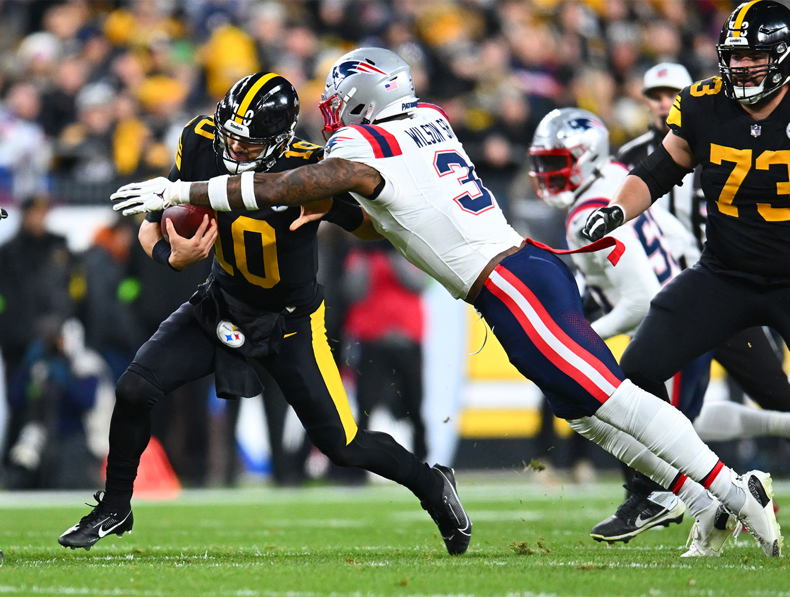 PITTSBURGH, PENNSYLVANIA - DECEMBER 07: Linebacker Mack Wilson Sr. (3) of the New England Patriots sacks quarterback Mitch Trubisky (10) of the Pittsburgh Steelers in the first half at Acrisure Stadium on December 07, 2023 in Pittsburgh, Pennsylvania. (Photo by Joe Sargent/Getty Images)
