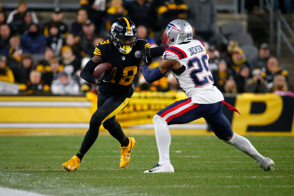 PITTSBURGH, PENNSYLVANIA - DECEMBER 07: Diontae Johnson #18 of the Pittsburgh Steelers stiff arms J.C. Jackson #29 of the New England Patriots in the second half at Acrisure Stadium on December 07, 2023 in Pittsburgh, Pennsylvania. (Photo by Justin K. Aller/Getty Images)