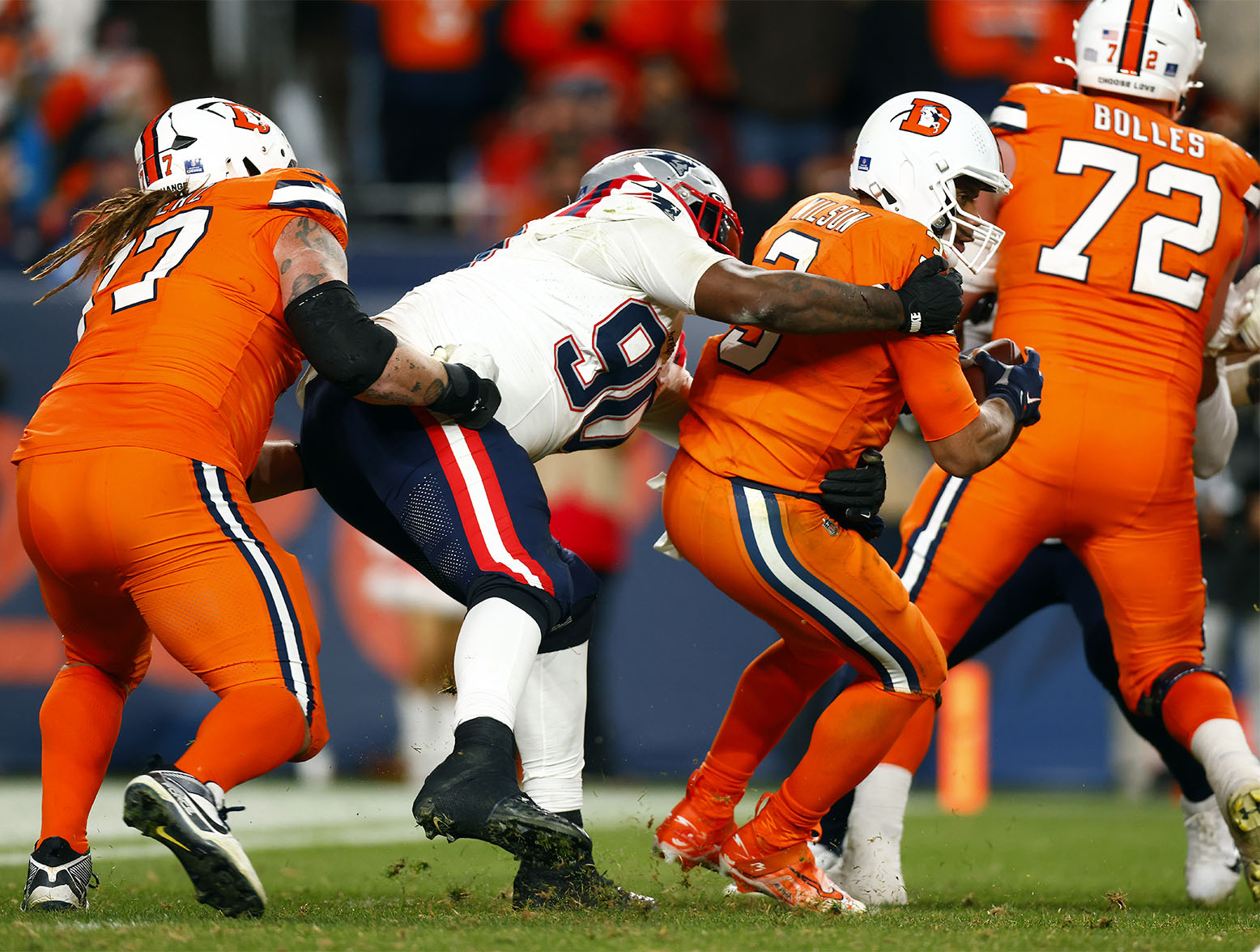 DENVER, COLORADO - DECEMBER 24: Defensive tackle Christian Barmore #90 of the New England Patriots sacks Russell Wilson #3 of the Denver Broncos during the 3rd quarter of the game at Empower Field At Mile High on December 24, 2023 in Denver, Colorado. (Photo by Justin Edmonds/Getty Images)