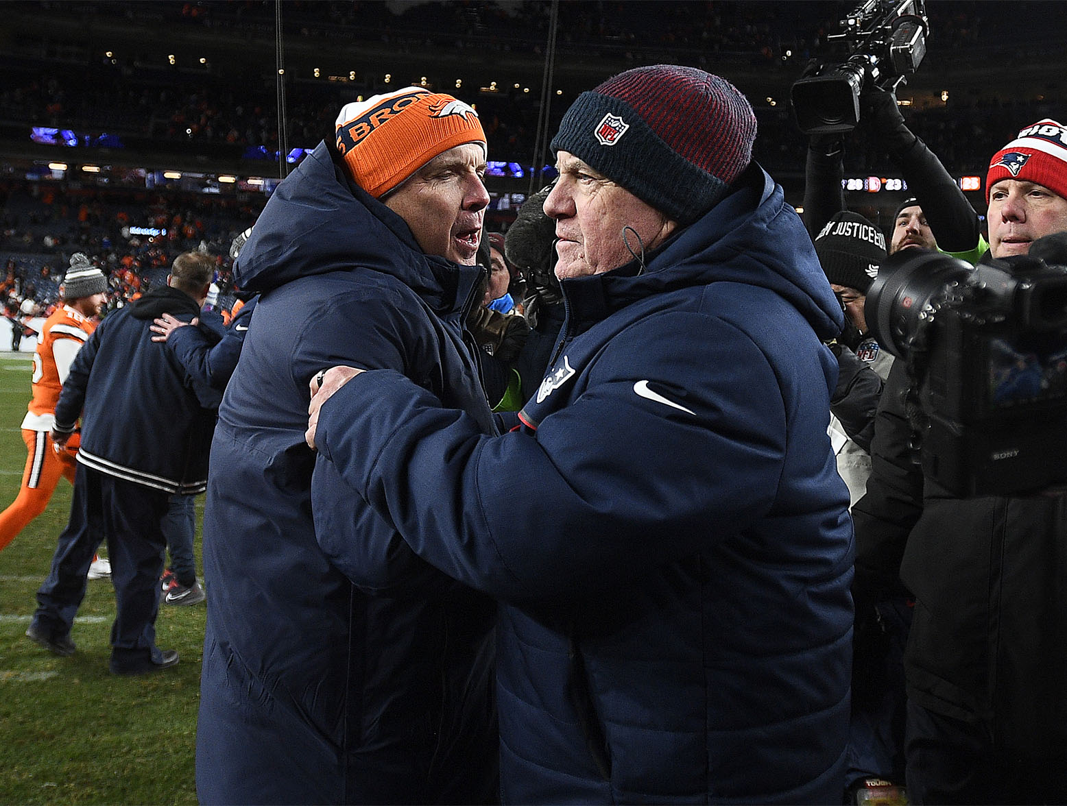DENVER, COLORADO - DECEMBER 24: Head coach Sean Payton of the Denver Broncos greets head coach Bill Belichick of the New England Patriots after the game at Empower Field At Mile High on December 24, 2023 in Denver, Colorado. (Photo by Dustin Bradford/Getty Images)