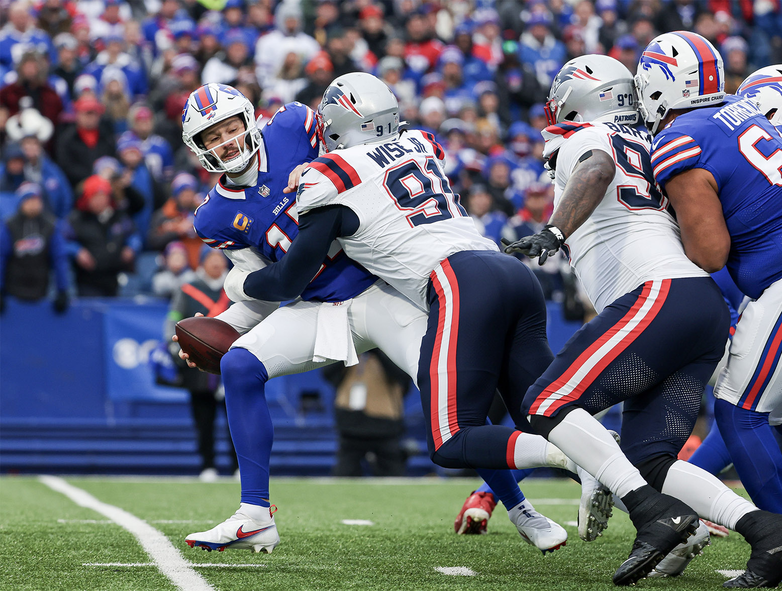 ORCHARD PARK, NEW YORK - DECEMBER 31: Deatrich Wise Jr. #91 of the New England Patriots sacks Josh Allen #17 of the Buffalo Bills during the first quarter at Highmark Stadium on December 31, 2023 in Orchard Park, New York. (Photo by Timothy T Ludwig/Getty Images)