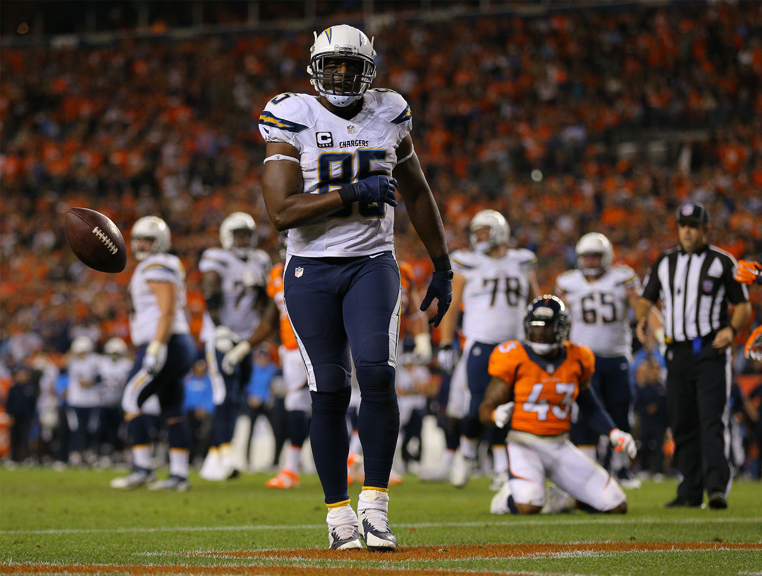 DENVER, CO - OCTOBER 23:  Tight end Antonio Gates #85 of the San Diego Chargers tosses the ball after a 4 yard touchdown reception in the third quarter of a game against the Denver Broncos at Sports Authority Field at Mile High on October 23, 2014 in Denver, Colorado.  (Photo by Justin Edmonds/Getty Images)