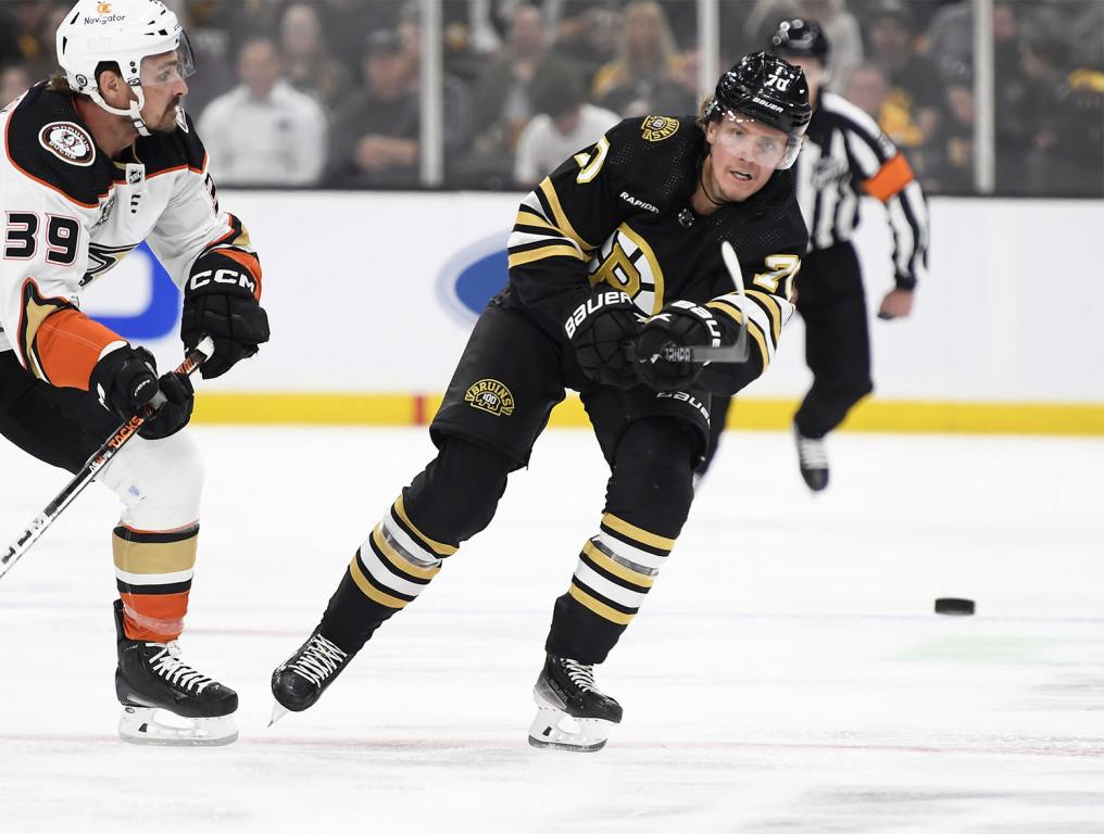 Oct 26, 2023; Boston, Massachusetts, USA; Boston Bruins defenseman Jesper Boqvist (70) shoots the puck while Anaheim Ducks center Sam Carrick (39) defends during the first period at TD Garden. Mandatory Credit: Bob DeChiara-USA TODAY Sports