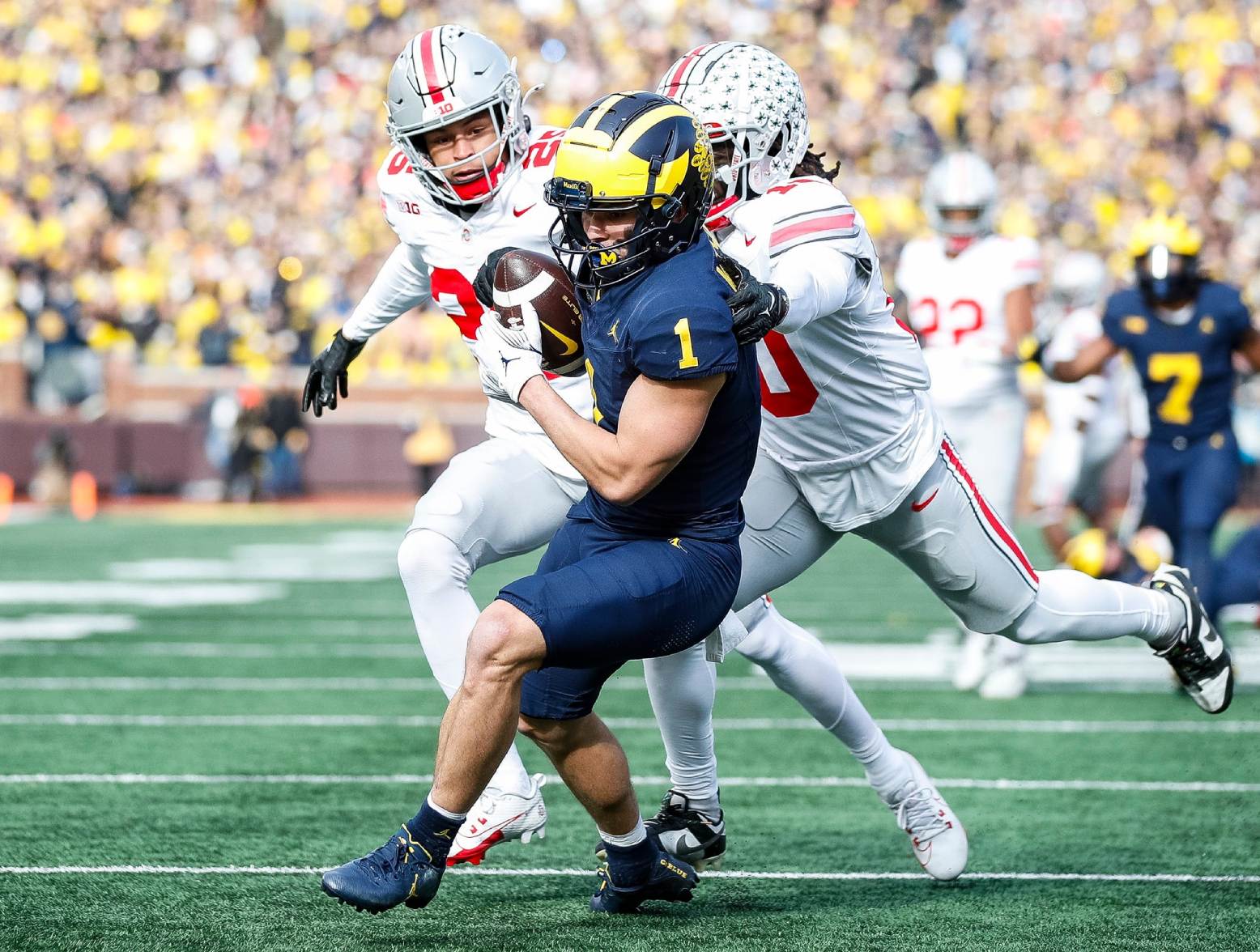 Michigan wide receiver Roman Wilson makes a catch against Ohio State safety Malik Hartford and cornerback Denzel Burke during the first half at Michigan Stadium in Ann Arbor on Saturday, Nov. 25, 2023. (Junfu Han/USA Today Network)