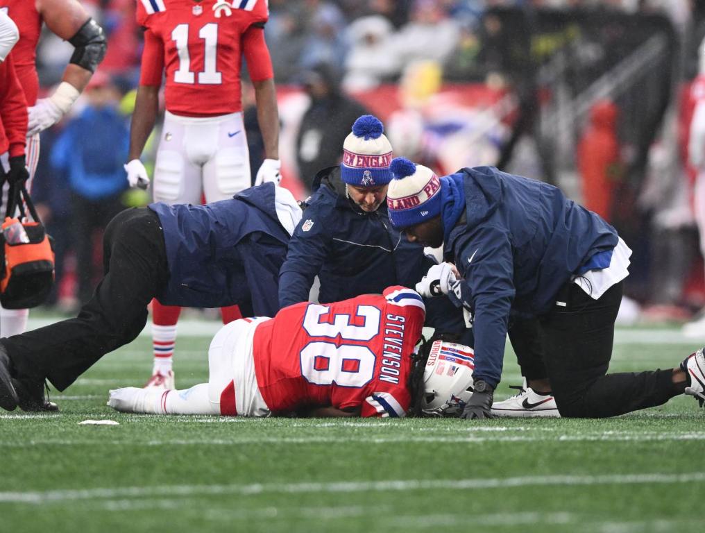 Dec 3, 2023; Foxborough, Massachusetts, USA; New England Patriots running back Rhamondre Stevenson (38) is helped by the athletic staff after an injury on a play against the Los Angeles Chargers during the first half at Gillette Stadium. Credit: Brian Fluharty-USA TODAY Sports