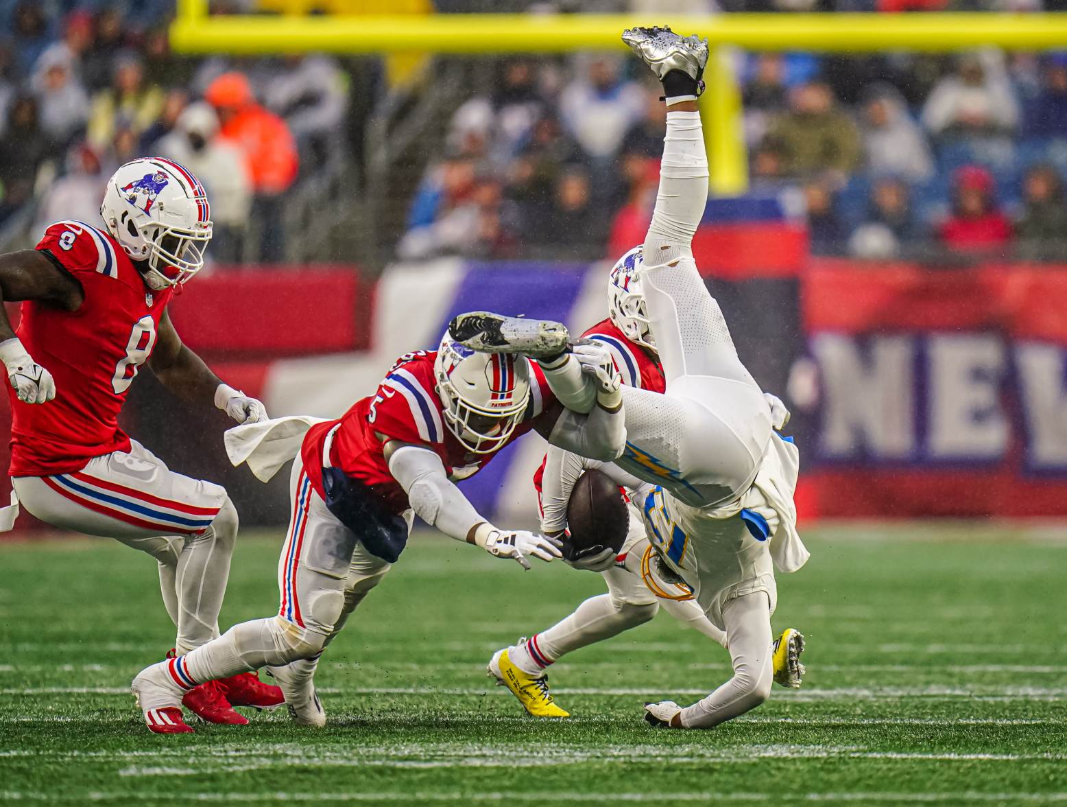 Dec 3, 2023; Foxborough, Massachusetts, USA; Los Angeles Chargers wide receiver Keenan Allen (13) is tackled by New England Patriots safety Jabrill Peppers (5) in the second half at Gillette Stadium. Credit: David Butler II-USA TODAY Sports