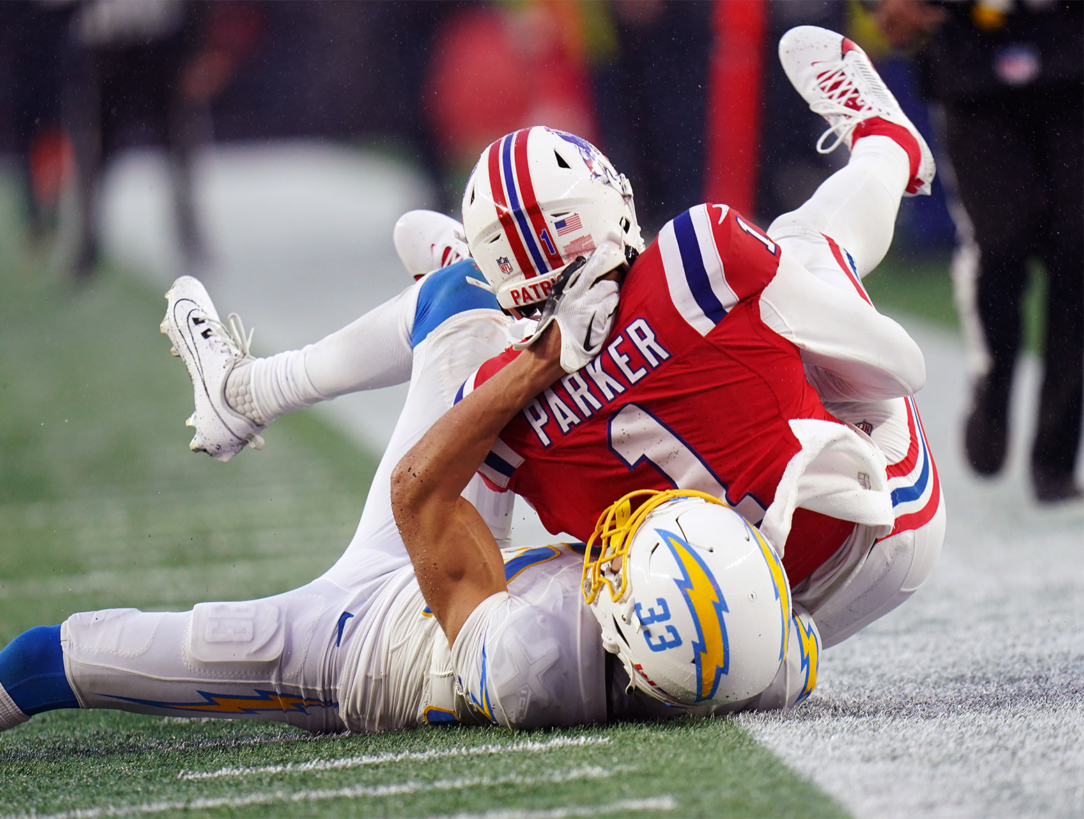 Dec 3, 2023; Foxborough, Massachusetts, USA; New England Patriots wide receiver DeVante Parker (1) ruled no catch out of bounds against Los Angeles Chargers cornerback Deane Leonard (33) in the second half at Gillette Stadium. Mandatory Credit: David Butler II-USA TODAY Sports