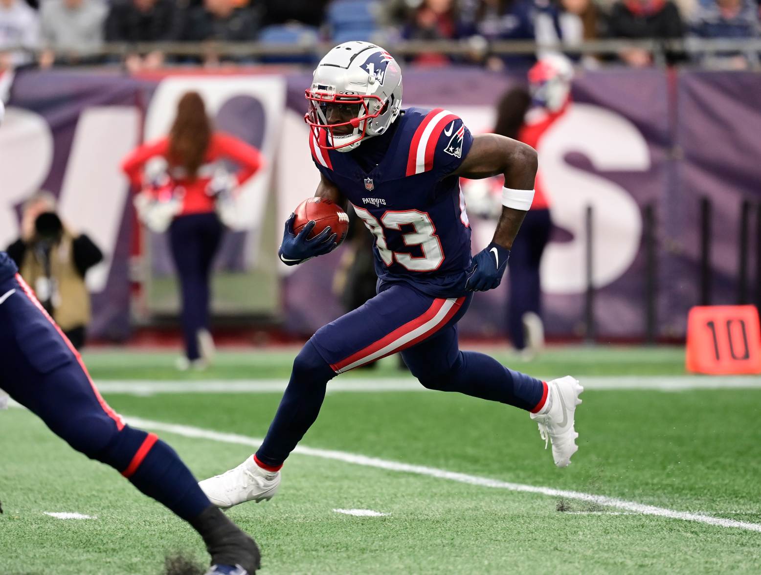 Dec 17, 2023; Foxborough, Massachusetts, USA; New England Patriots wide receiver Jalen Reagor (83) returns the ball during the first half against the Kansas City Chiefs at Gillette Stadium. Credit: Eric Canha-USA TODAY Sports