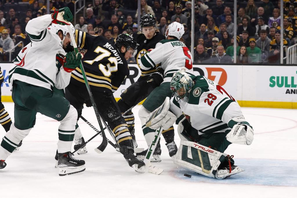 Dec 19, 2023; Boston, Massachusetts, USA; Boston Bruins defenseman Charlie McAvoy (73) looks for a rebound under Minnesota Wild goaltender Marc-Andre Fleury (29) during the third period at TD Garden. Mandatory Credit: Winslow Townson-USA TODAY Sports