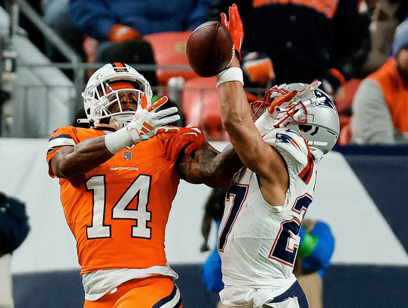 Dec 24, 2023; Denver, Colorado, USA; New England Patriots cornerback Myles Bryant (27) deflects a pass intended for Denver Broncos wide receiver Courtland Sutton (14) in the first quarter at Empower Field at Mile High. Mandatory Credit: Isaiah J. Downing-USA TODAY Sports