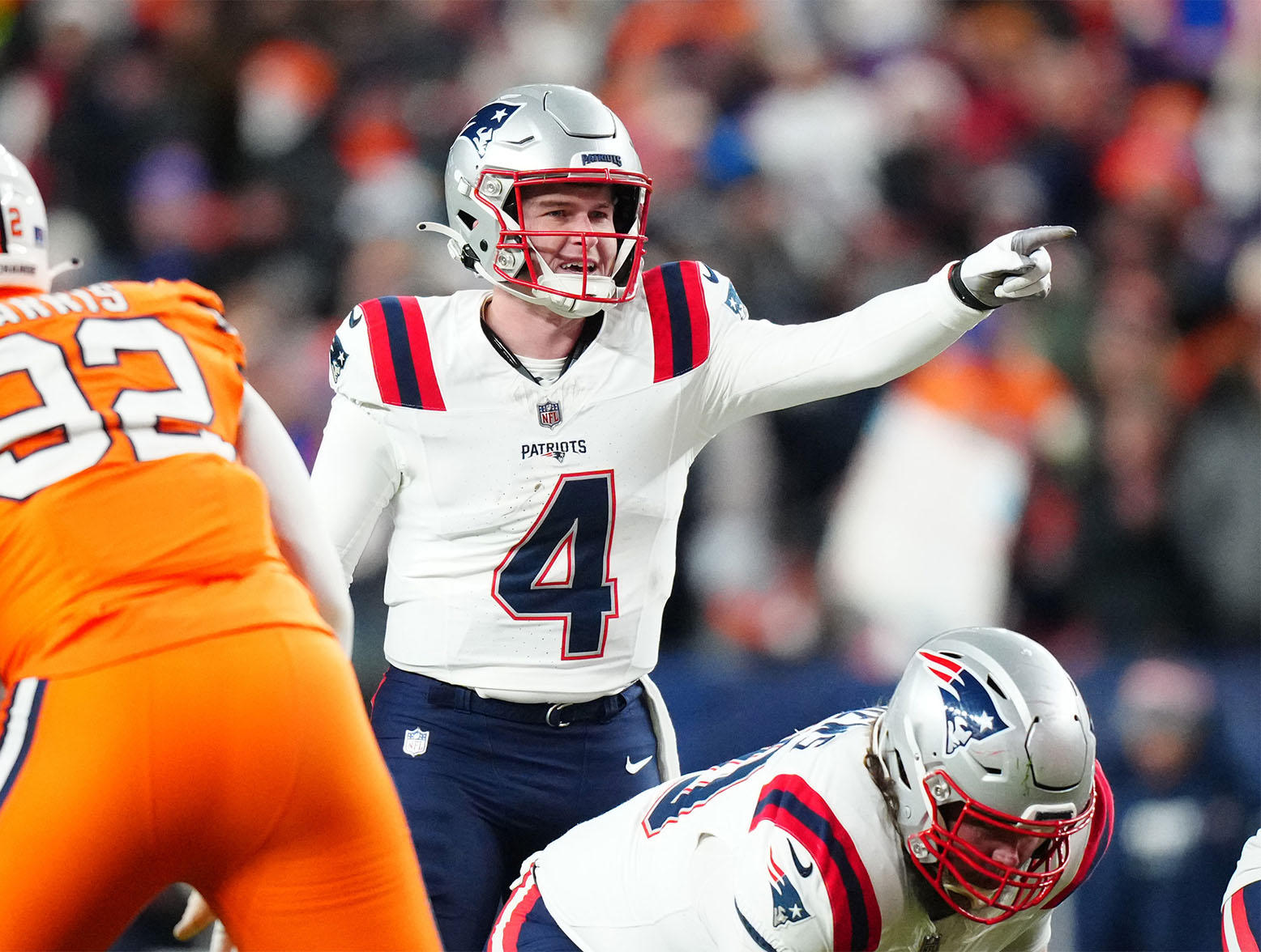 Dec 24, 2023; Denver, Colorado, USA; New England Patriots quarterback Bailey Zappe (4) calls out in the first half against the Denver Broncos at Empower Field at Mile High. Mandatory Credit: Ron Chenoy-USA TODAY Sports