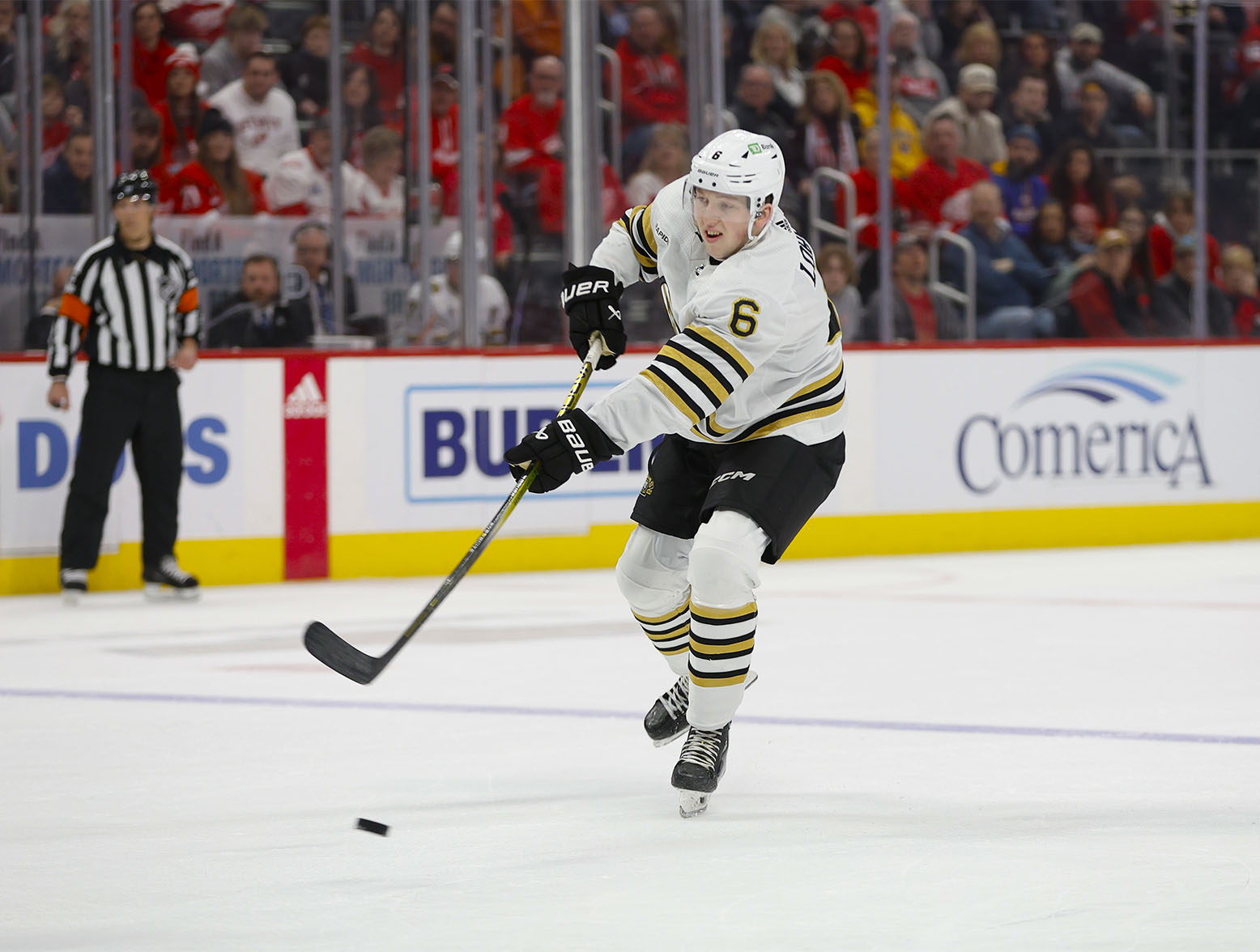 Dec 31, 2023; Detroit, Michigan, USA; Boston Bruins defenseman Mason Lohrei (6) shoots the puck during the first period of the game between the Boston Bruins and the Detroit Red Wings at Little Caesars Arena. Mandatory Credit: Brian Bradshaw Sevald-USA TODAY Sports