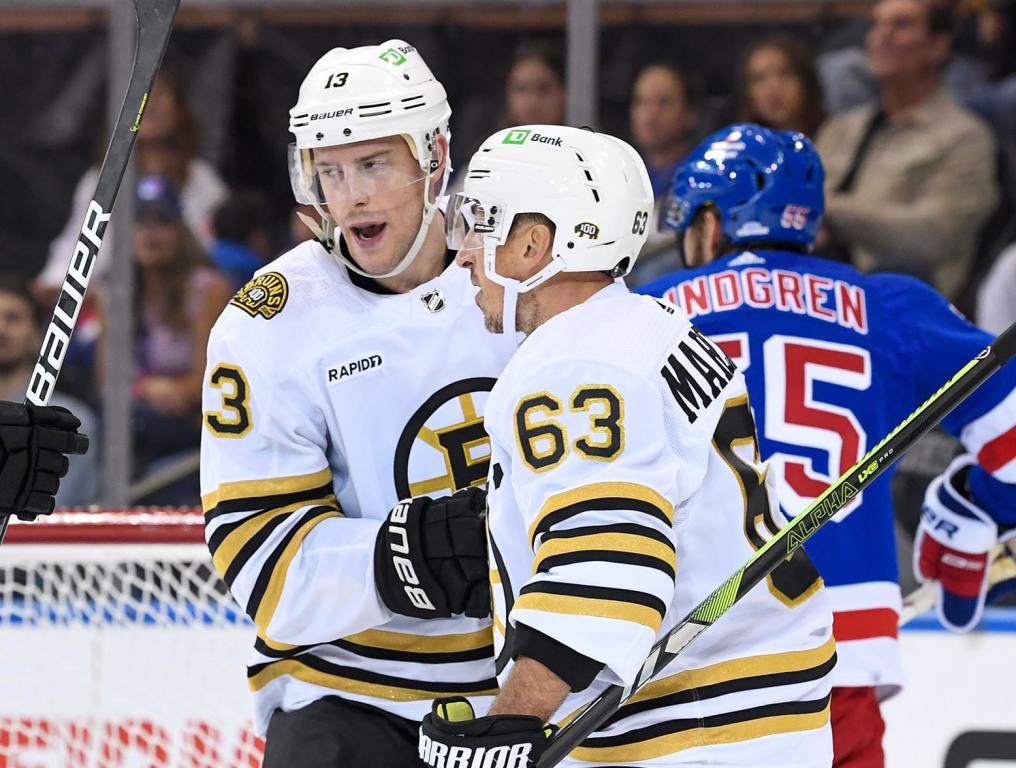 Oct 5, 2023; New York, New York, USA; Boston Bruins center Charlie Coyle (13) celebrates his goal with left wing Brad Marchand (63) against the New York Rangers during the second at Madison Square Garden. Mandatory Credit: Dennis Schneidler-USA TODAY Sports