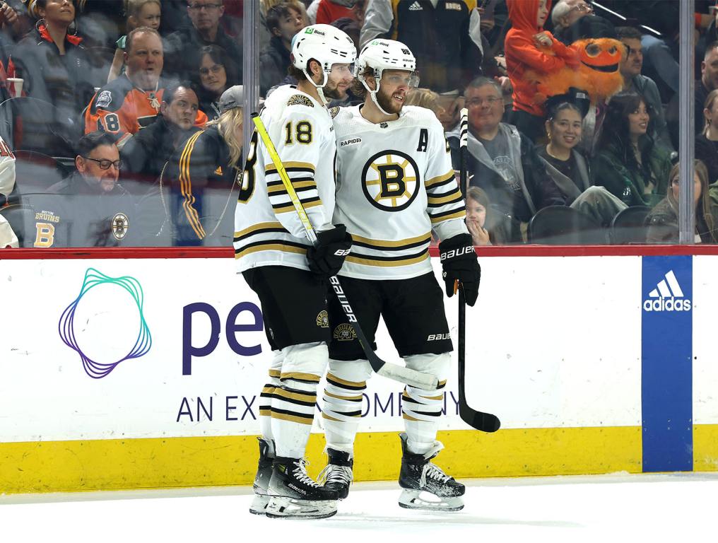 PHILADELPHIA, PENNSYLVANIA - JANUARY 27: Pavel Zacha #18 and David Pastrnak #88 of the Boston Bruins react following a goal by Pastrnak during the first period against the Philadelphia Flyers at the Wells Fargo Center on January 27, 2024 in Philadelphia, Pennsylvania. (Photo by Tim Nwachukwu/Getty Images)