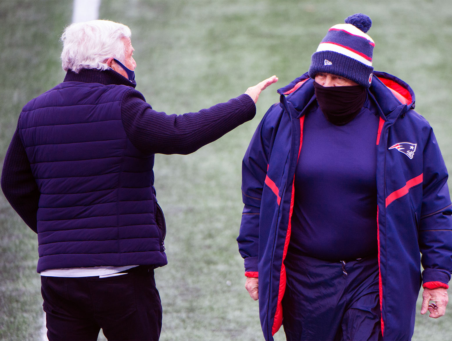 FOXBOROUGH, MA - JANUARY 3, 2021: New England Patriots owner Robert Kraft (L) pats head coach Bill Belichick on the shoulder during warmups prior to the start of the game against the New York Jets at Gillette Stadium on January 3, 2021 in Foxborough, Massachusetts. (Photo by Kathryn Riley/Getty Images)