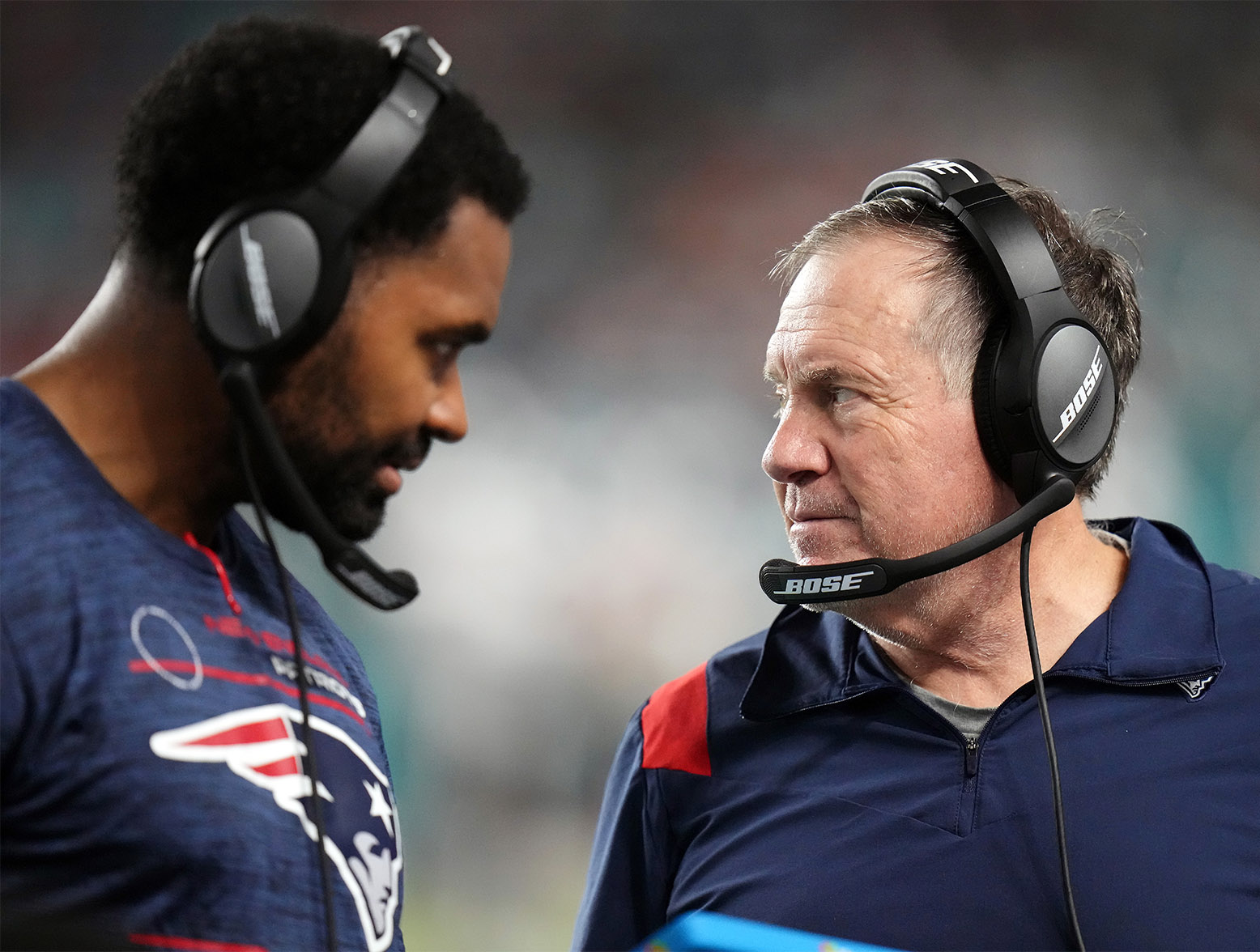 MIAMI GARDENS, FLORIDA - JANUARY 09: Head coach Bill Belichick of the New England Patriots and inside linebackers coach Jerod Mayo talk on the sidelines in the fourth quarter of the game against the Miami Dolphins at Hard Rock Stadium on January 09, 2022 in Miami Gardens, Florida. (Photo by Mark Brown/Getty Images)