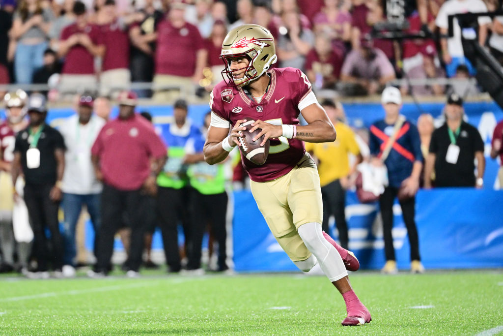 ORLANDO, FLORIDA - SEPTEMBER 03: Jordan Travis #13 of the Florida State Seminoles scrambles out of the pocket in the first quarter against the LSU Tigers at Camping World Stadium on September 03, 2023 in Orlando, Florida. (Photo by Julio Aguilar/Getty Images)
