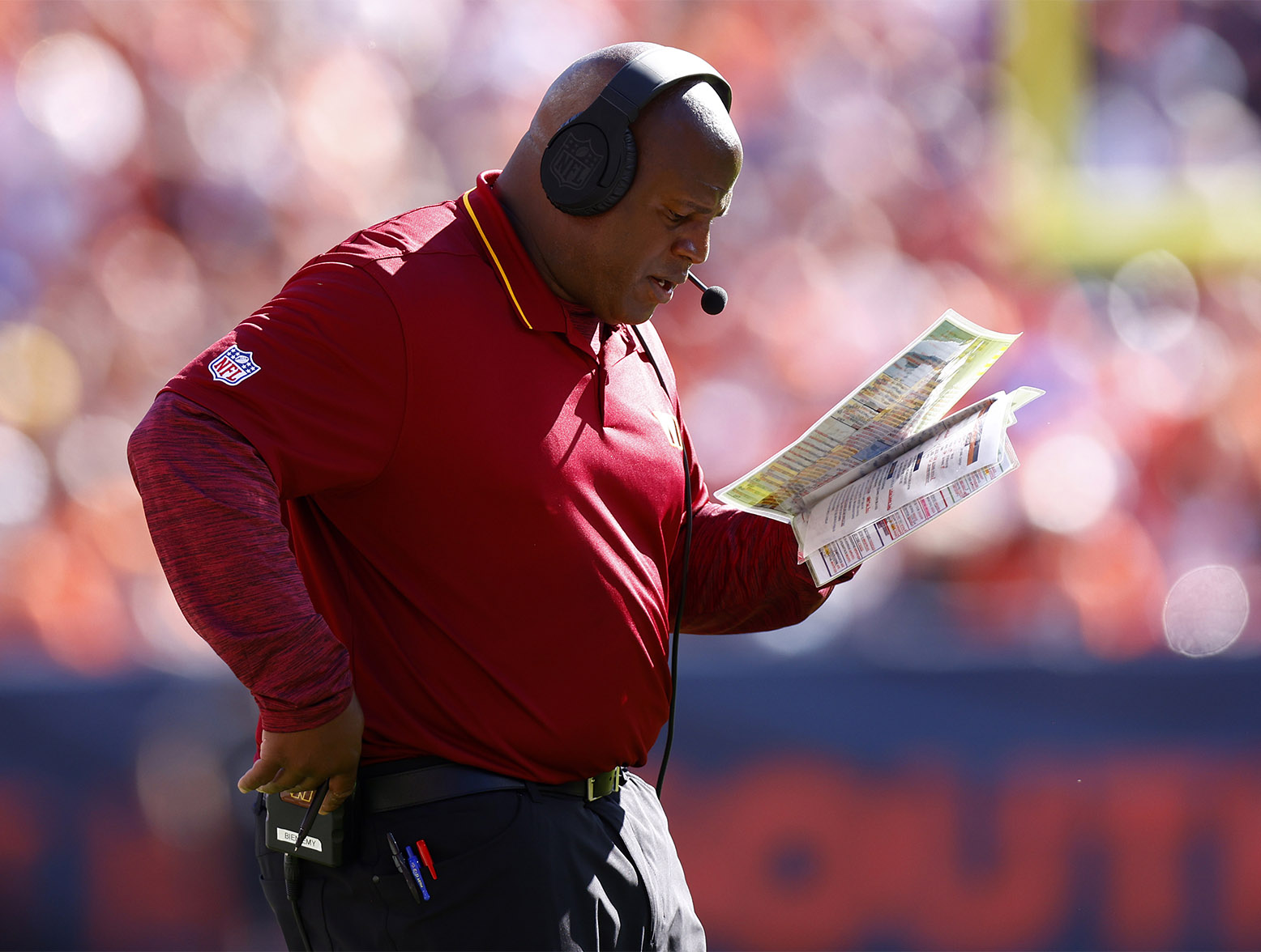 DENVER, COLORADO - SEPTEMBER 17: Offensive coordinator Eric Bieniemy of the Washington Commanders looks at his play calling sheet during the second quarter against the Denver Broncos at Empower Field At Mile High on September 17, 2023 in Denver, Colorado. (Photo by Justin Edmonds/Getty Images)