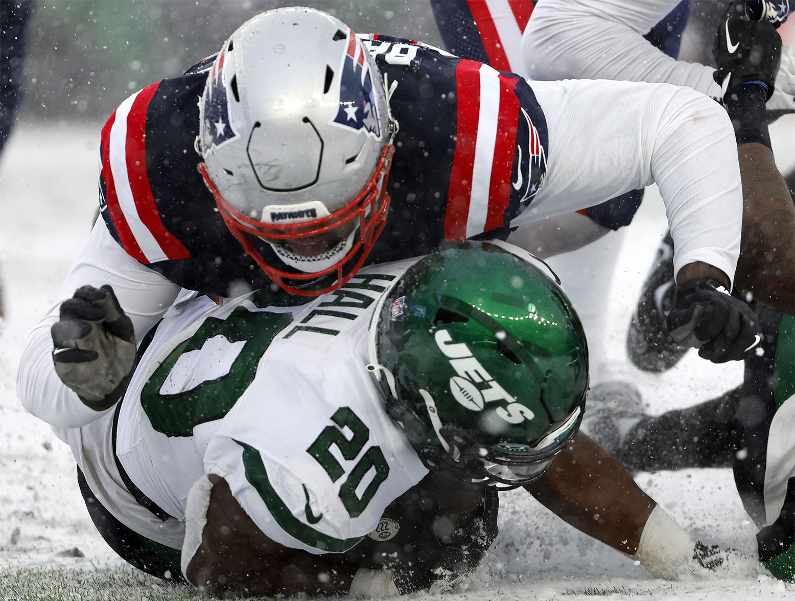 FOXBOROUGH, MASSACHUSETTS - JANUARY 07: Christian Barmore #90 of the New England Patriots tackles Breece Hall #20 of the New York Jets in the second half during a game at Gillette Stadium on January 07, 2024 in Foxborough, Massachusetts. (Photo by Winslow Townson/Getty Images)