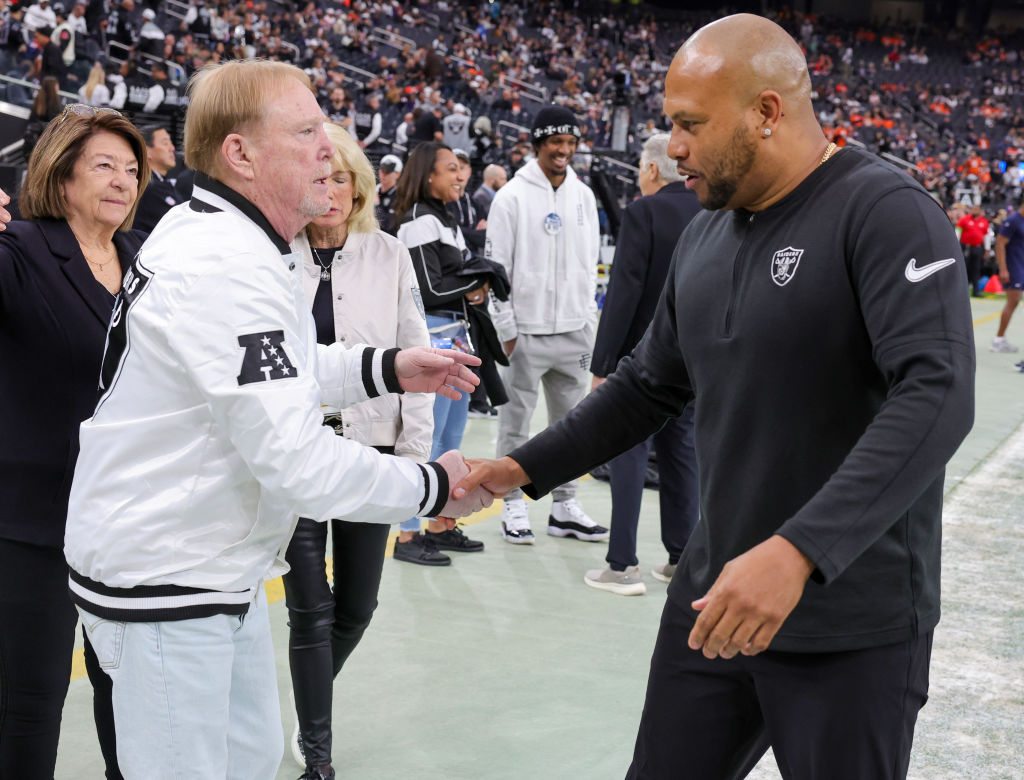 LAS VEGAS, NEVADA - JANUARY 07: Owner and managing general partner Mark Davis (L) and interim head coach Antonio Pierce of the Las Vegas Raiders greet each other on the Raiders' sideline before the team's game against the Denver Broncos at Allegiant Stadium on January 07, 2024 in Las Vegas, Nevada. The Raiders defeated the Broncos 27-14. (Photo by Ethan Miller/Getty Images)