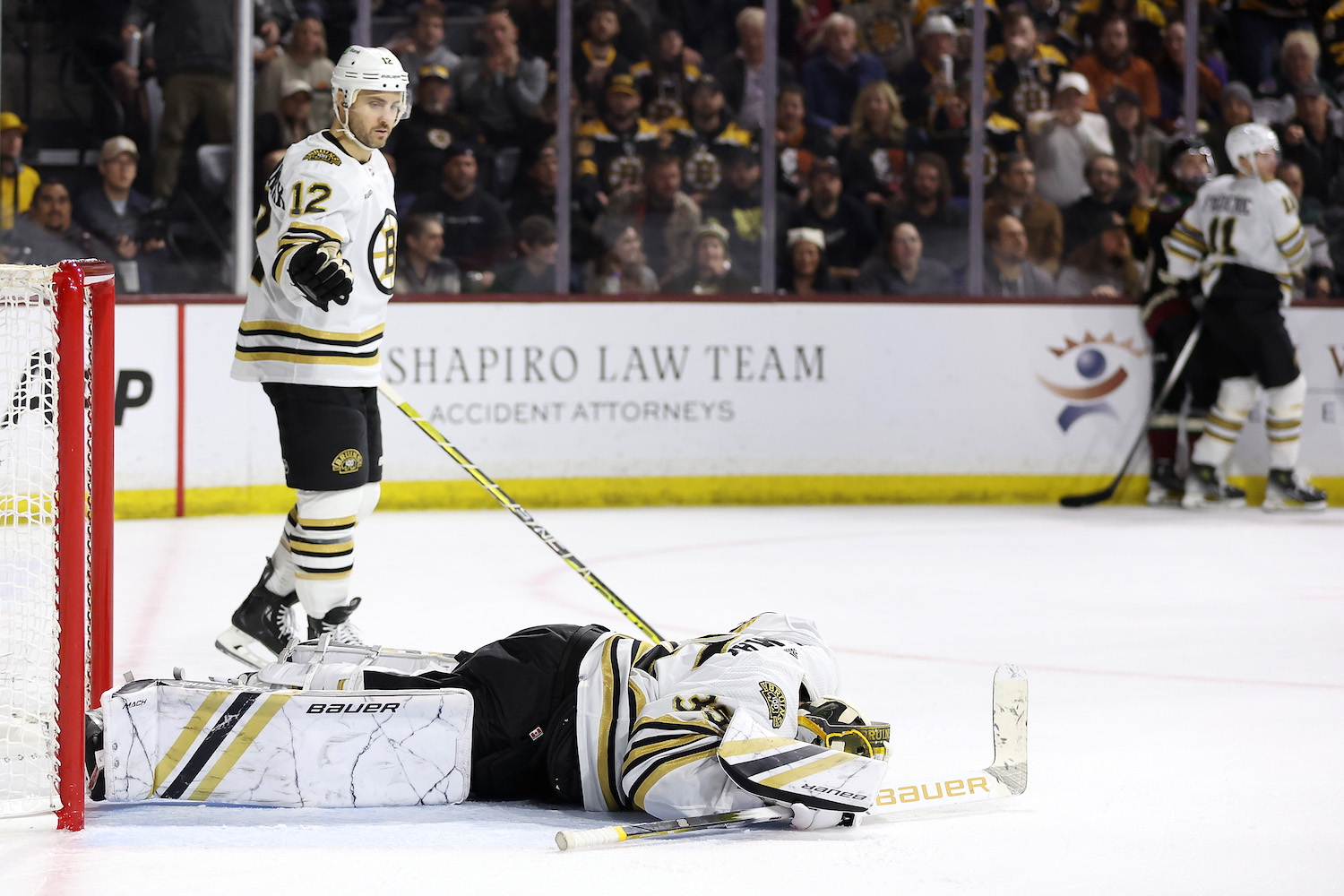 TEMPE, ARIZONA - JANUARY 09: Goaltender Linus Ullmark #35 of the Boston Bruins lays on the ice after an injury in overtime against the Arizona Coyotes at Mullett Arena on January 09, 2024 in Tempe, Arizona. The Coyotes defeated the Bruins 4-3 in overtime. (Photo by Christian Petersen/Getty Images)