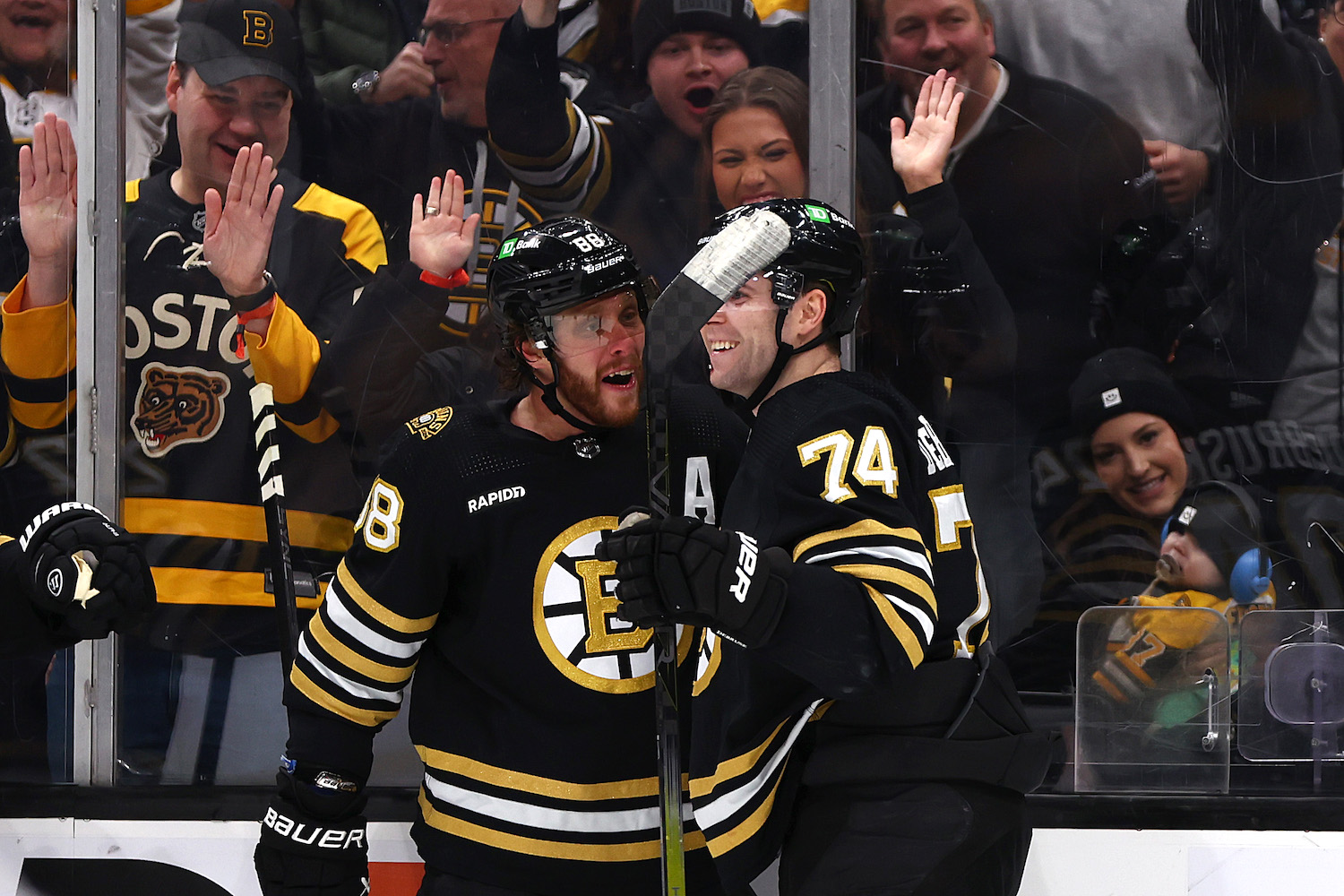 BOSTON, MASSACHUSETTS - JANUARY 18: David Pastrnak #88 of the Boston Bruins celebrates with Jake DeBrusk #74 after scoring against the Colorado Avalanche during the third period at TD Garden on January 18, 2024 in Boston, Massachusetts. The Bruins defeat the Avalanche 5-2. (Photo by Maddie Meyer/Getty Images)