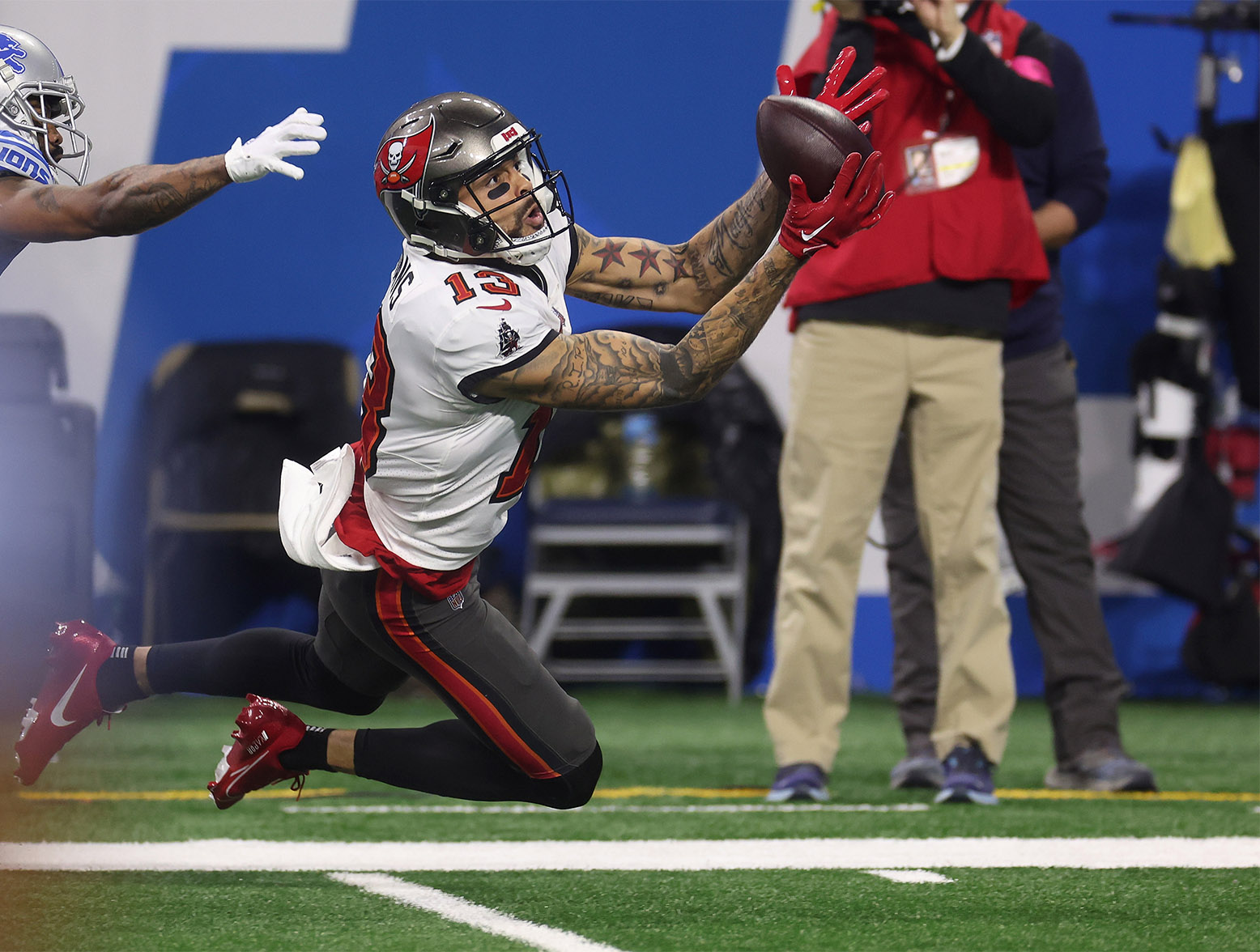 DETROIT, MICHIGAN - JANUARY 21: Mike Evans #13 of the Tampa Bay Buccaneers catches a pass in front of Cameron Sutton #1 of the Detroit Lions during the second quarter of the NFC Divisional Playoff game at Ford Field on January 21, 2024 in Detroit, Michigan. (Photo by Gregory Shamus/Getty Images)