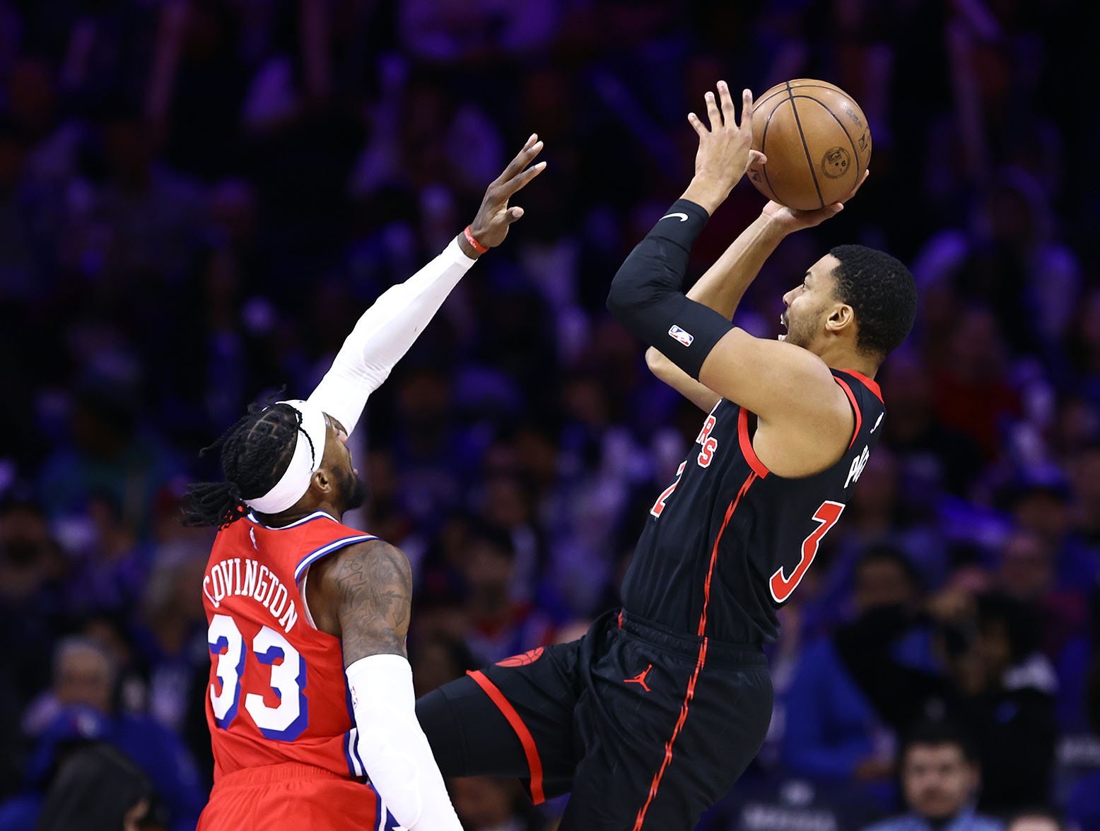 PHILADELPHIA, PENNSYLVANIA - DECEMBER 22: Otto Porter Jr. #32 of the Toronto Raptors shoots over Robert Covington #33 of the Philadelphia 76ers during the fourth quarter at the Wells Fargo Center on December 22, 2023 in Philadelphia, Pennsylvania. (Photo by Tim Nwachukwu/Getty Images)