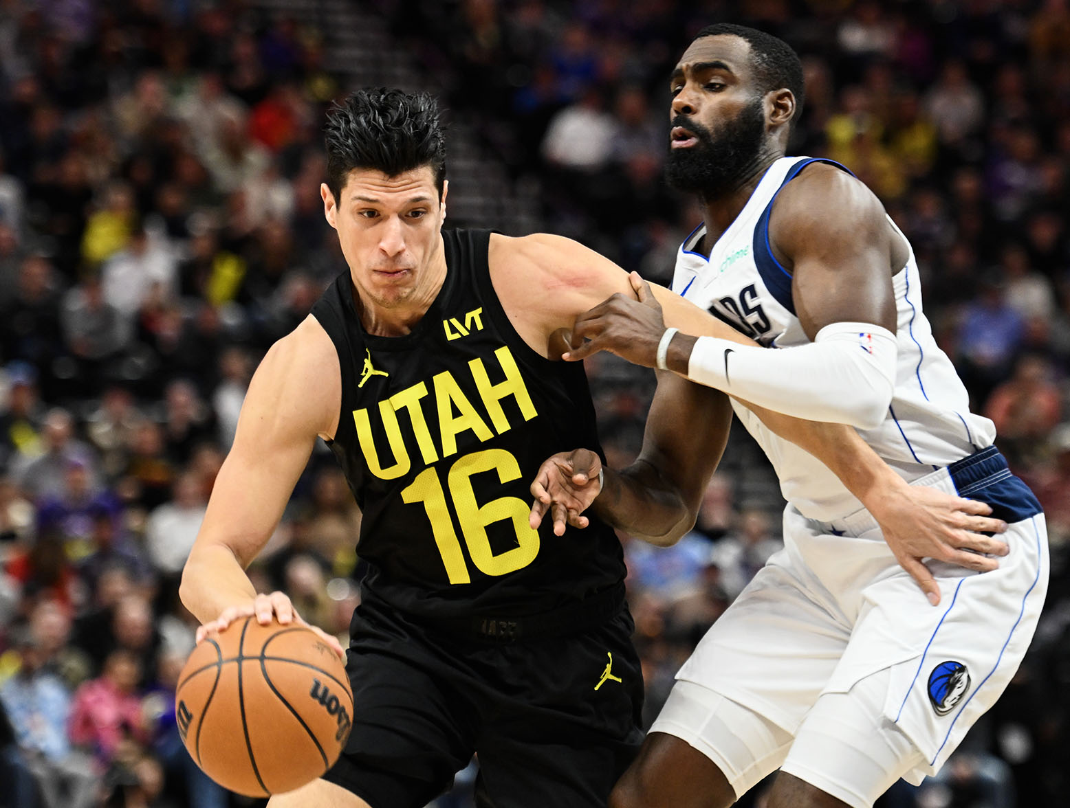 SALT LAKE CITY, UTAH - JANUARY 01: Simone Fontecchio #16 of the Utah Jazz drives past Tim Hardaway Jr. #10 of the Dallas Mavericks during the first half of a game at Delta Center on January 01, 2024 in Salt Lake City, Utah. (Photo by Alex Goodlett/Getty Images)