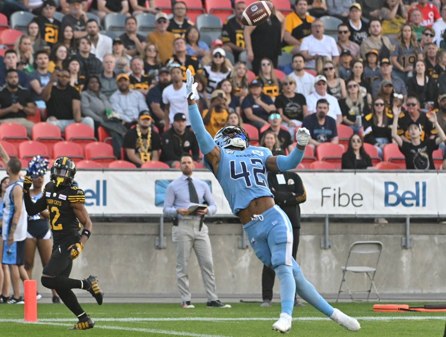 Jun 18, 2023; Toronto, Ontario, CAN; Toronto Argonauts defensive back Qwan'tez Stiggers (42) reaches up to intercept a pass intended for Hamilton Tiger-Cats wide receiver Tim White (12) in the first quarter at BMO Field. Credit: Dan Hamilton-USA TODAY Sports