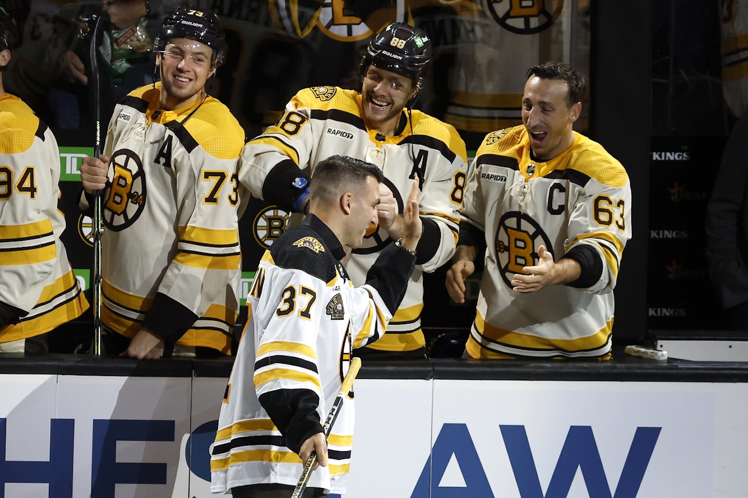 Oct 11, 2023; Boston, Massachusetts, USA; Former Boston Bruins captain Patrice Bergeron greets former teammates Boston Bruins right wing David Pastrnak (88) and left wing Brad Marchand (63) before the start of Boston’s 100th season in the NHL at TD Garden. Mandatory Credit: Winslow Townson-USA TODAY Sports