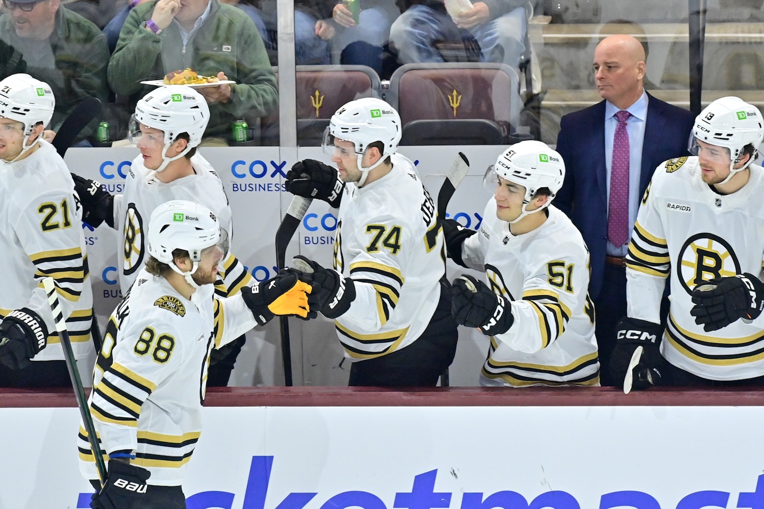 Jan 9, 2024; Tempe, Arizona, USA; Boston Bruins right wing David Pastrnak (88) celebrates with teammates after scoring a a power-play goal against in the first period against the Arizona Coyotes at Mullett Arena. Mandatory Credit: Matt Kartozian-USA TODAY Sports