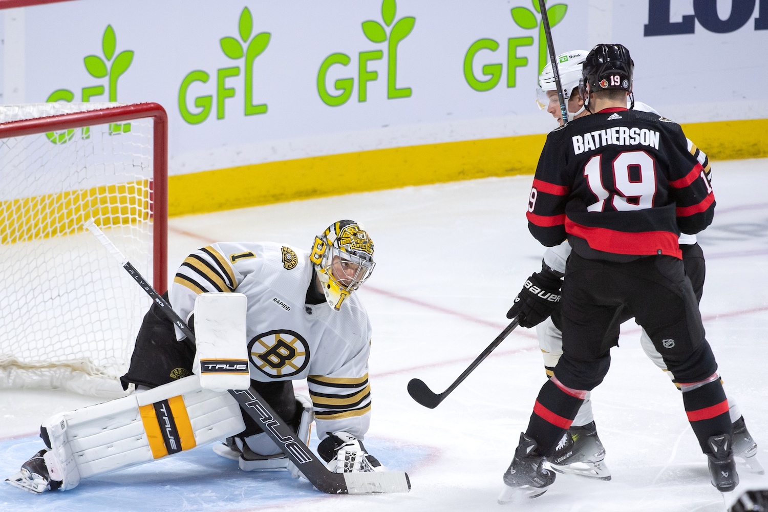 Jan 25, 2024; Ottawa, Ontario, CAN; Boston Bruins goalie Jeremy Swayman (1) makes a save in front of Ottawa Senators right wing Drake Batherson (19) in the third period at the Canadian Tire Centre. Mandatory Credit: Marc DesRosiers-USA TODAY Sports